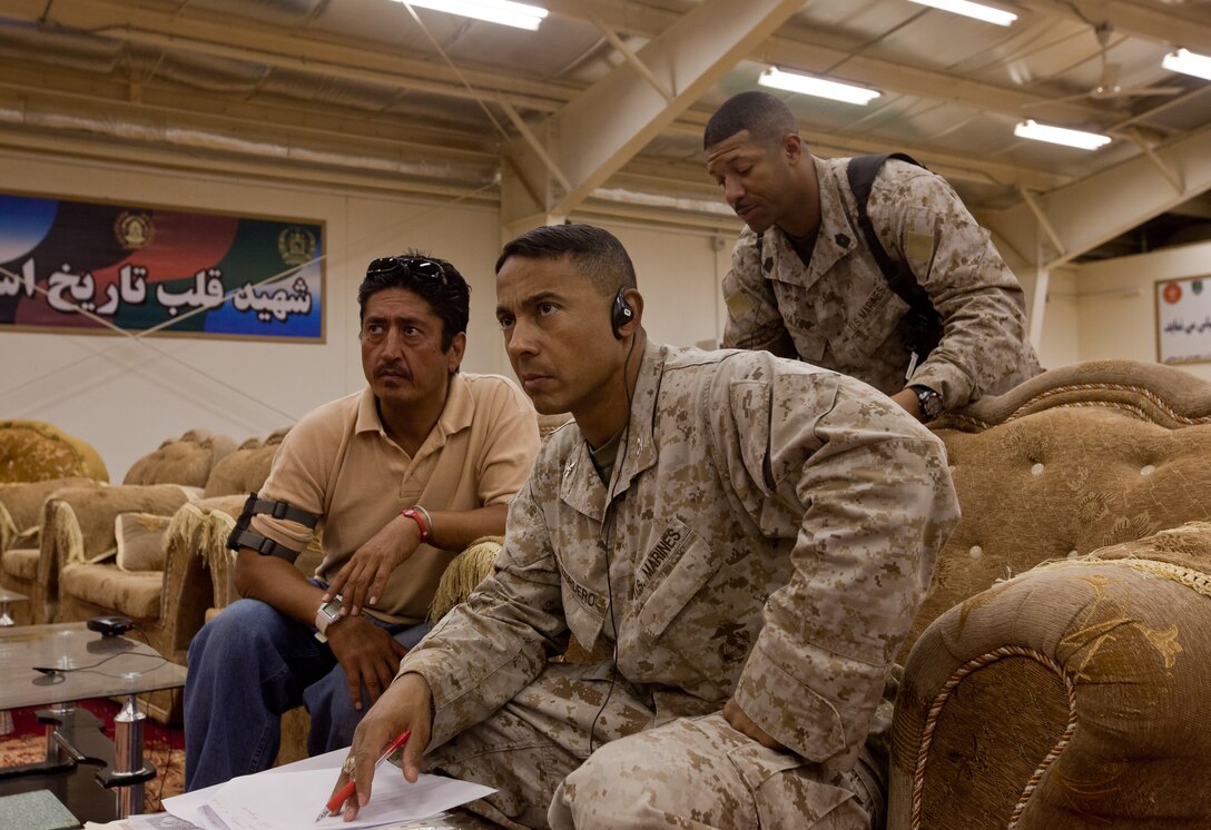 Col. Michael E. Cordero, comptroller for Regional Command Southwest, listens to a financial representative from the Afghan National Army’s 3rd Brigade, 215th Corps during a meeting at the Afghans’ headquarters at Camp Shorabak, Helmand province, Sept. 17. The purpose of the meeting was to discuss how to fix pay problems existing within the 215th Corps. 