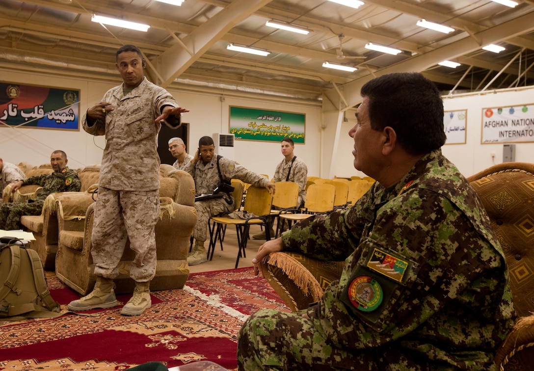 Col. Michael E. Cordero, comptroller for Regional Command Southwest, speaks with Brig. Gen. Ghulam Farouq Parwani, deputy commander of the  Afghan National Army’s 215th Corps, during a meeting at the Afghans’ headquarters at Camp Shorabak, Helmand province, Sept. 17. The purpose of the meeting was to discuss how to fix pay problems existing within the 215th Corps.