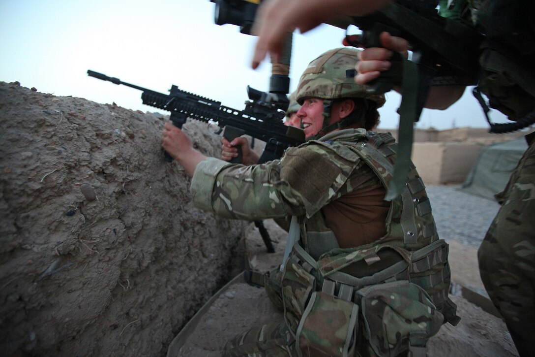 Able Seaman Heidi Telford gets in position on the perimeter of Checkpoint Salaang, Helmand province, alongside soldiers of 1st Battalion, The Rifles, as they provide cover for a patrol that came under fire from insurgents, Helmand province, June 11.Telford, a native of Plymouth, U.K., is a member of the Female Engagement Team and is currently assigned to the 1 Rifles Battle Group in the Nahr-e-Saraj district. 