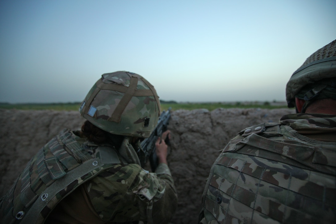Able Seaman Heidi Telford points her rifle in the direction of a compound where insurgents had just fired on a friendly patrol that was returning to Checkpoint Salaang, Helmand province, June 11. Telford, a native of Plymouth, U.K., is a member of the Female Engagement Team and is currently assigned to the 1 Rifles Battle Group in the Nahr-e-Saraj district. 