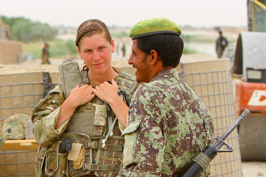 Able Seaman Heidi Telford converses with an Afghan soldier at the southern side of the Nahr-e-Bughra Canal, near Checkpoint Salaang, Helmand province, June 11. Telford, a native of Plymouth, U.K., is a member of the Female Engagement Team and is currently assigned to the 1 Rifles Battle Group in the Nahr-e-Saraj district. 