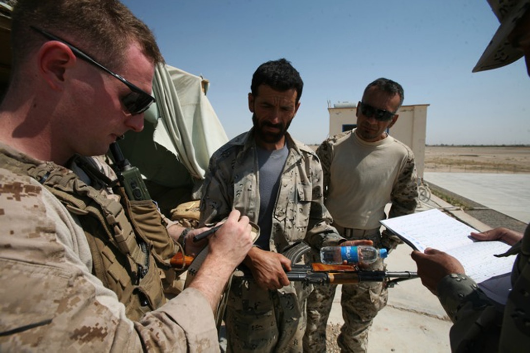 110619-N-XXXXS-041 LASHKAGAR (June 19, 2011) 1st Lt. Patrick Abell (left), 1st Company mentor for Border Advisor Team 1 stationed in Lashkagar, from Akron, Ohio  takes inventory of Afghan Border Police (ABP) weapons at Bost airfield Sunday, June 19.  The Border Advisor Team ensured every ABP member had his own weapon and that the weapons were well maintained. (Official U.S. Navy photo by Mass Communication Specialist 2nd Class Matt Snodgrass/Released)