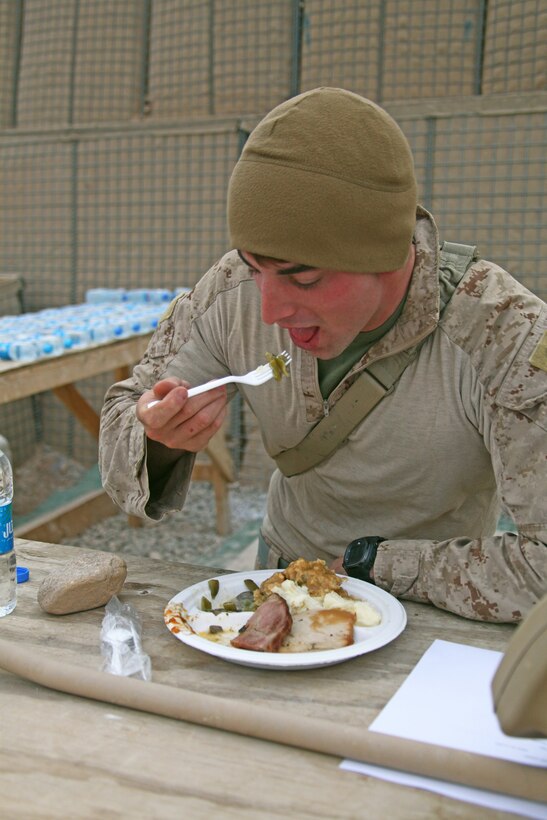 Sgt. Tobler Turner, a squad leader with Weapons Company, 1st Battalion, 25th Marine Regiment, and a native of Boonesville, Ark., eats his Thanksgiving dinner at Patrol Base Boldak, Helmand province, Nov. 24. Marines on Patrol Base Boldak were served their Thanksgiving meal by Lt. Col. Brian O’Leary, commanding officer of 1/25, Maj. Bruce Stoffolano, commanding officer of Weapons Co., 1/25, Sgt. Maj. Andrew Tomelleri, sergeant major of 1/25 and 1st Sgt. Adam Sheinkin, company first sergeant of Weapons Co., 1/25, after they convoyed from Camp Leatherneck to spend the holiday with their Marines. 