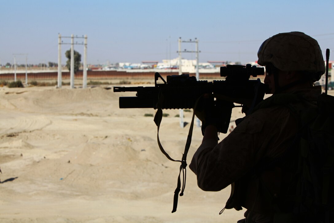 Sgt. Anton Hoffman, a native of West Hartford, Conn. with Scout Sniper Platoon, 1st Battalion, 25th Marine Regiment provides security for key ISAF coordinators and plans developers during a site visit to Zaranj in Nimroz province. The engagement between ISAF and Government of the Islamic Republic of Afghanistan officials was to discuss the improvement of both security and infrastructure in the region.