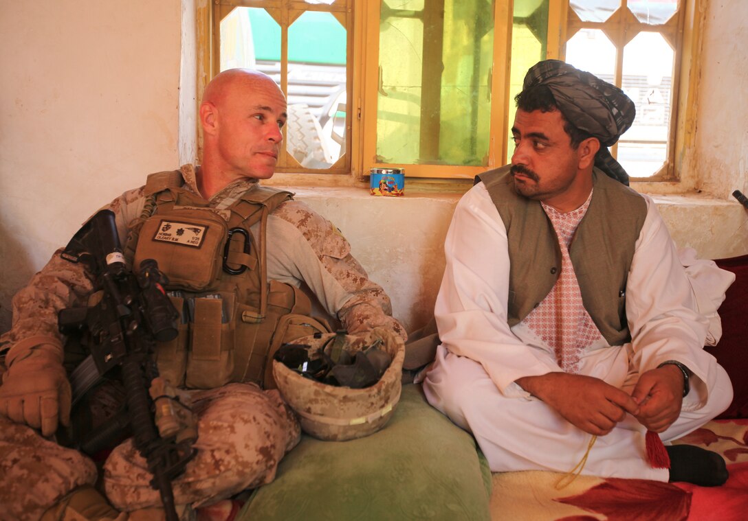 Lt. Col. Brian O’Leary, commander of 1st Battalion, 25th Marine Regiment, and Daod Mohammad, the district governor of Washir, conduct a shura with Afghan shopkeepers at a bazaar located on the northern perimeter of Camp Leatherneck, Helmand province, Sept. 29. The purpose of the meeting was to discuss moving all of the squatters located outside of the base to a more secure location farther north. 