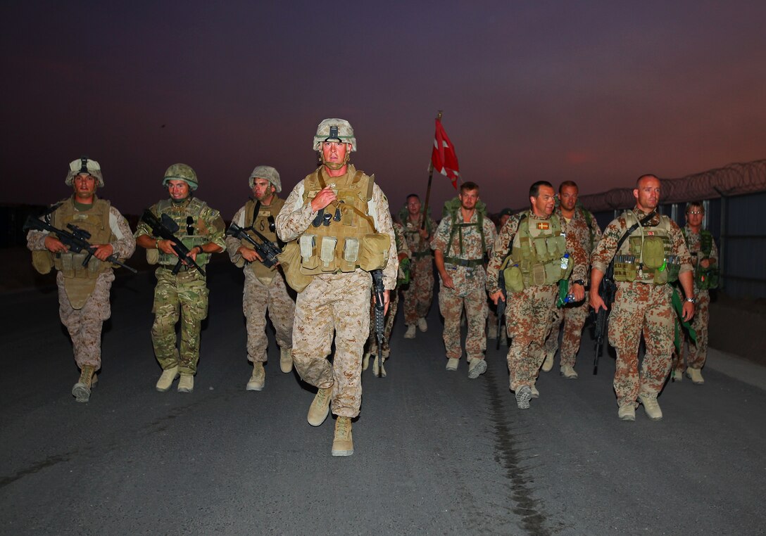 Coalition service members march together during the Danish Contingent March aboard Camp Leatherneck, July 26. The DANCON march is a 15-mile endurance contest held by Danish troops wherever they are deployed.