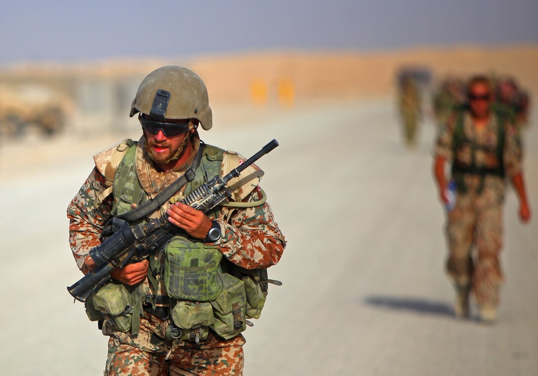Private First Class Stiig Gade, a driver with Transport Platoon, Danish Battle Group, runs with a full combat load during Danish Contingent March aboard Camp Leatherneck, July 26. The DANCON march is a 15-mile endurance contest held by Danish troops wherever they are deployed.