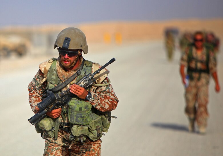 Private First Class Stiig Gade, a driver with Transport Platoon, Danish Battle Group, runs with a full combat load during Danish Contingent March aboard Camp Leatherneck, July 26. The DANCON march is a 15-mile endurance contest held by Danish troops wherever they are deployed.