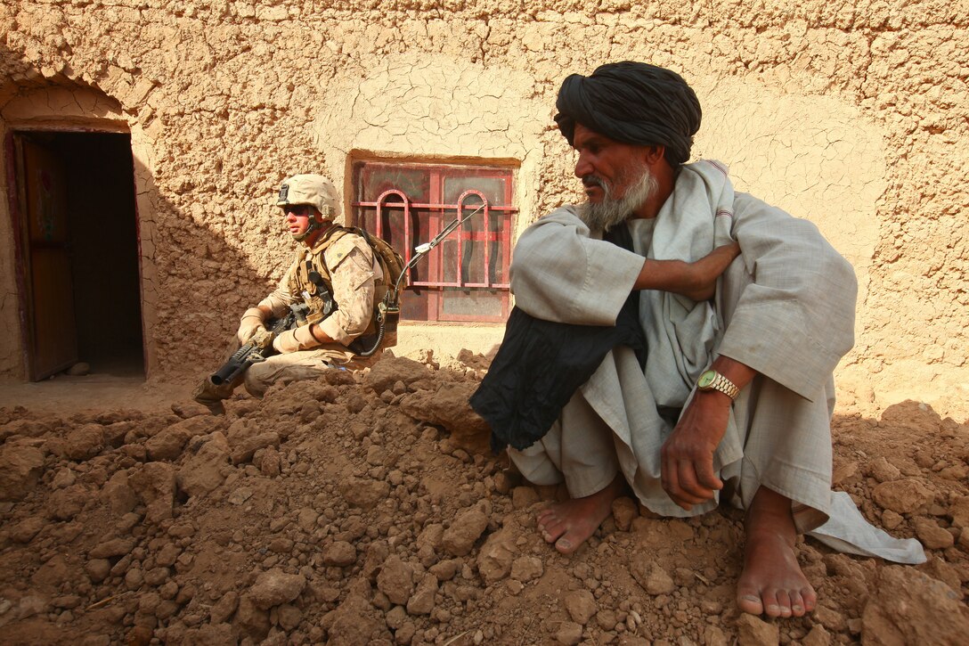 Sgt. Josh Coldwell, an assistant patrol leader with Mobile Assault Platoon 4, Weapons Company, 1st Battalion, 25th Marine Regiment and native of Berlin, Mass., collects information from Afghan villagers during a patrol in the southern portion of the Washir district, Helmand province, Oct. 4. The Marines of Weapons Company, 1st Bn., 25th Marines have been familiarizing themselves with the southern border of Task Force Belleau Wood’s battlespace since arriving in Afghanistan in September.