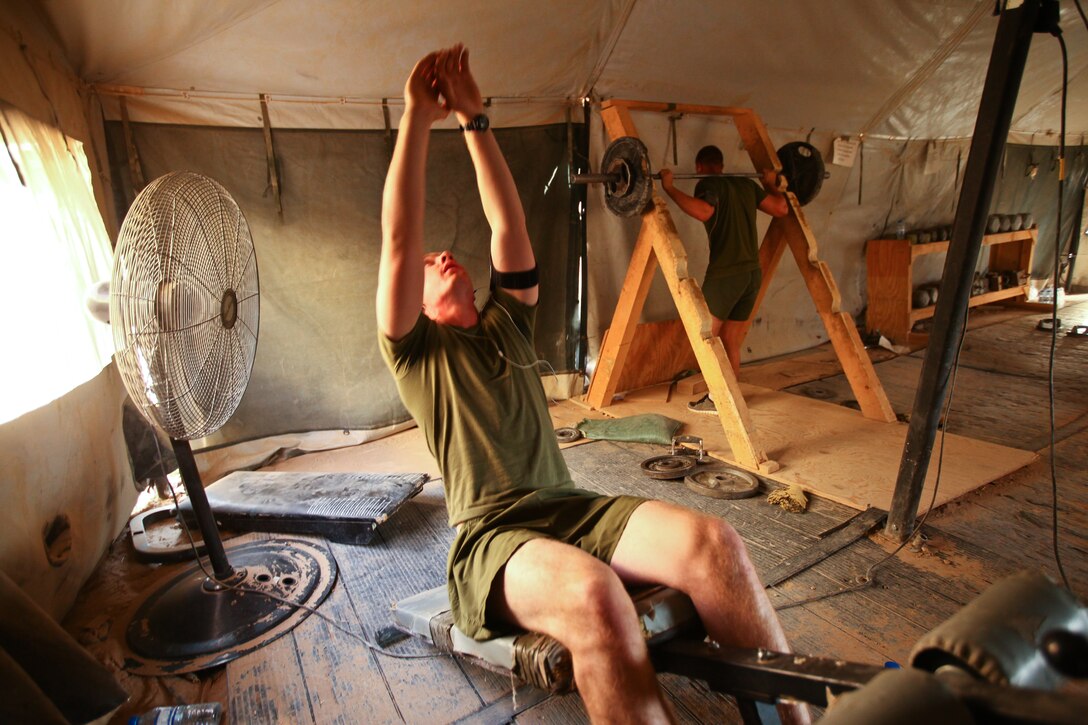 Cpl. Russ McDonald (left) and Lance Cpl. Justen Kazan, both mortarmen with Weapons Company, 1st Battalion, 25th Marine Regiment, and natives of Boston, Mass., exercise in the “prison gym” at Patrol Base Boldak, Helmand province, Sept. 30. Boldak is the first line of defense for Camp Leatherneck, the largest coalition base in Helmand province. It is manned by Weapons Co., 1st Bn., 25th Marines, a reservist unit based out of Fort Devens, Mass.