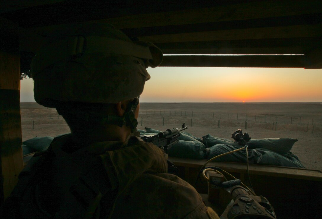 Lance Cpl. Adam Chaffee, a mortarman with Weapons Company, 1st Battalion, 25th Marine Regiment, and a native of Charlestown, N.H., watches the sun set while manning a post at Patrol Base Boldak, Helmand province, Oct. 3. Boldak is the first line of defense for Camp Leatherneck, the largest coalition base in Helmand province. It is manned by Weapons Co., 1st Bn., 25th Marines, a reservist unit based out of Fort Devens, Mass.