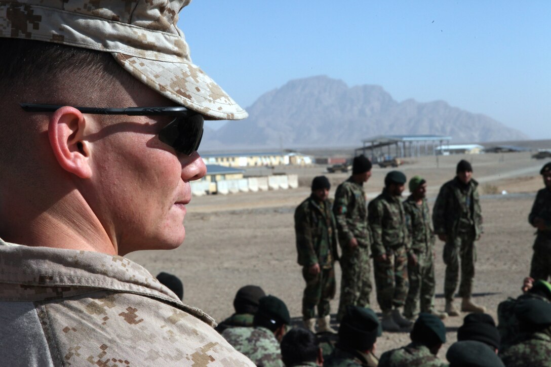 – Sgt. Patrick Lynch, assistant operations chief, from Harrisburg, Penn., watches members of the Afghan National Army as they prepare to practice a dismounted patrol after receiving a class from him aboard Forward Operating Base Delaram I, Feb. 14. Marines with Embedded Training Team, Regimental Combat Team 6 have a mission of training and advising members of the ANA.