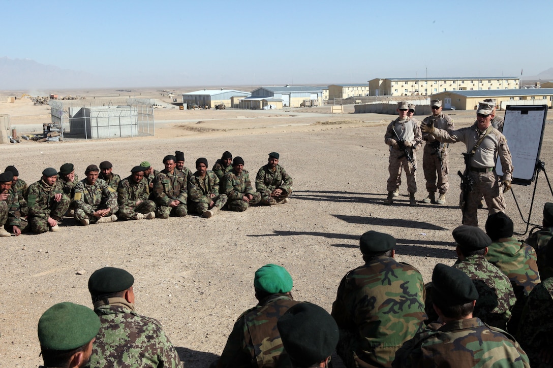 Sgt. Patrick Lynch, assistant operations chief, from Harrisburg, Penn. , gives a class to members of the Afghan National Army, aboard Forward Operating Base Delaram I, Feb. 14. Marines with Embedded Training Team, Regimental Combat Team 6 have a mission of training and advising members of the ANA.