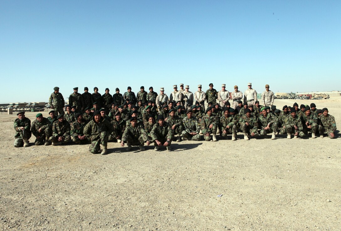 Marines with Embedded Training Team, Regimental Combat Team 6, and soldiers with the Afghan National Army pose for a photo after an instructional period aboard Forward Operating Base Delaram I, Feb. 14. Marines with Embedded Training Team, Regimental Combat Team 6 have a mission of training and advising members of the ANA.