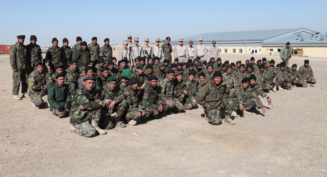 Marines with Embedded Training Team, Regimental Combat Team 6, and soldiers with the Afghan National Army pose for a photo after an instructional period aboard Forward Operating Base Delaram I, Feb. 14. Marines with Embedded Training Team, Regimental Combat Team 6 have a mission of training and advising members of the ANA.