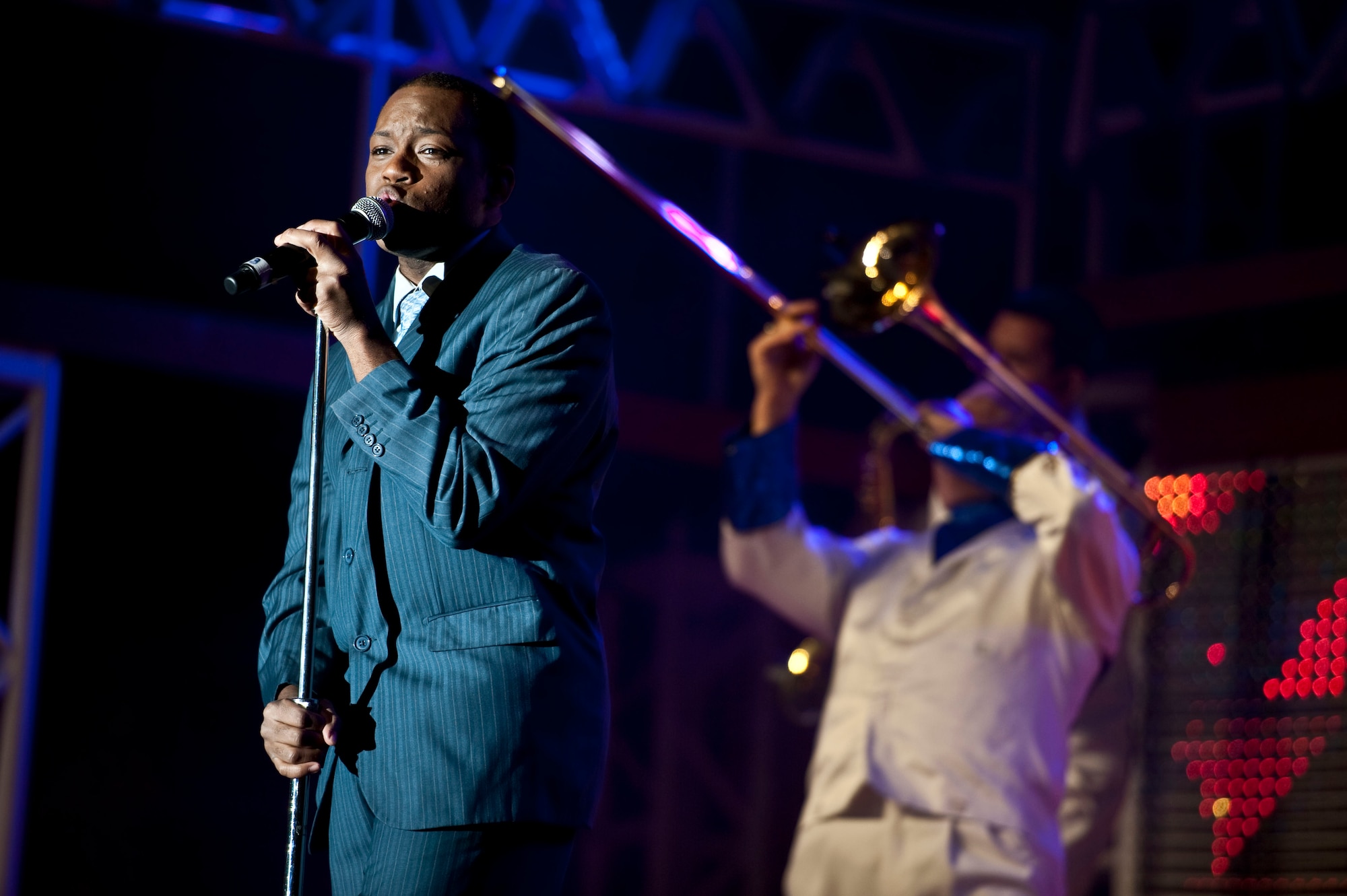 Staff Sgt. Tommie Crutcher, a Tops in Blue performer, sings during a performance at the Freedom Hangar on Hurlburt Field, Fla., Feb. 11, 2012. Tops in BlueÕs tour schedule includes concerts in more than 120 locations around the world. (U.S. Air Force Photo/Airman 1st Class Hayden K. Hyatt) (Released)

