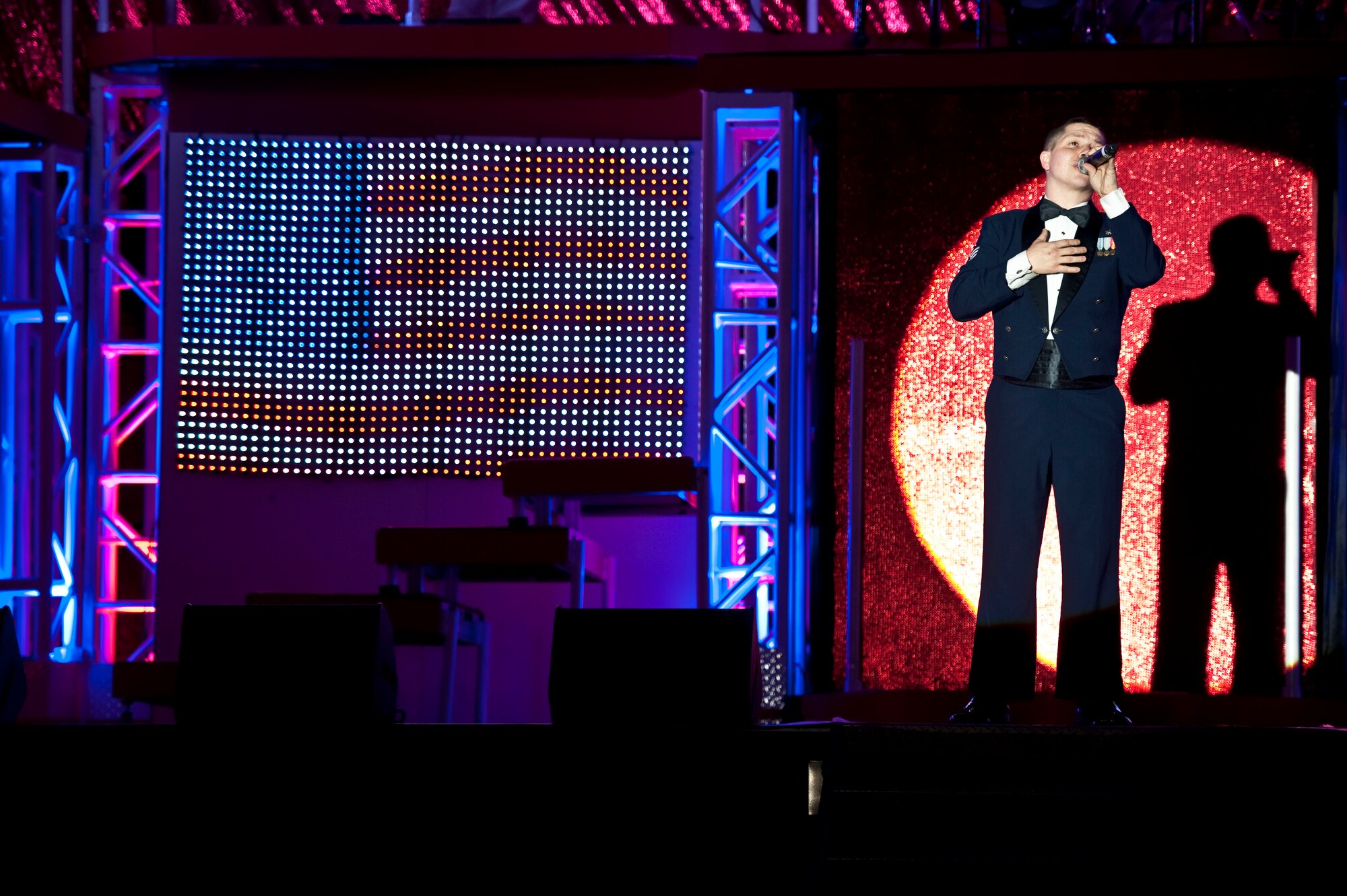 Senior Airman Zachary Rayburn, a Tops in Blue performer, sings during a concert at the Freedom Hangar on Hurlburt Field, Fla., Feb. 11, 2012. Tops in Blue's 2011 tour, "Rhythm Nation," detailed America's music throughout the 20th century. (U.S. Air Force Photo/Airman 1st Class Hayden K. Hyatt) (Released)