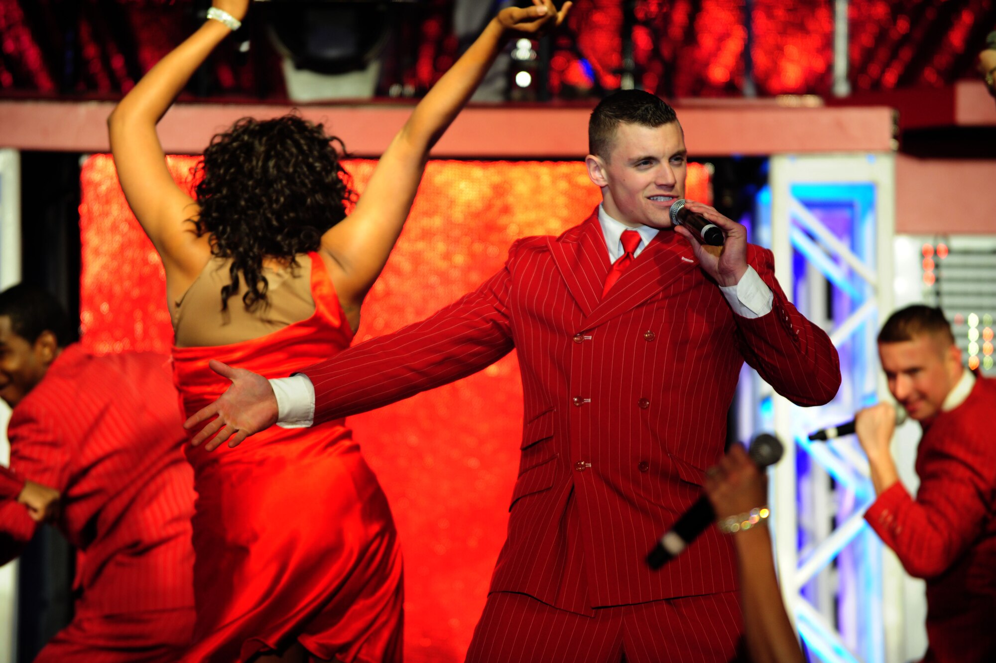 1st Lt. Robert Doyle, a Tops in Blue performer, entertains an audience at a concert inside the Freedom Hangar on Hurlburt Field, Fla., Feb. 11, 2012.  Tops in Blue?s 2011 tour, ?Rhythm Nation,? detailed America?s music throughout the 20th century. (U.S. Air Force photo/Airman 1st Class Gustavo Castillo)(Released)