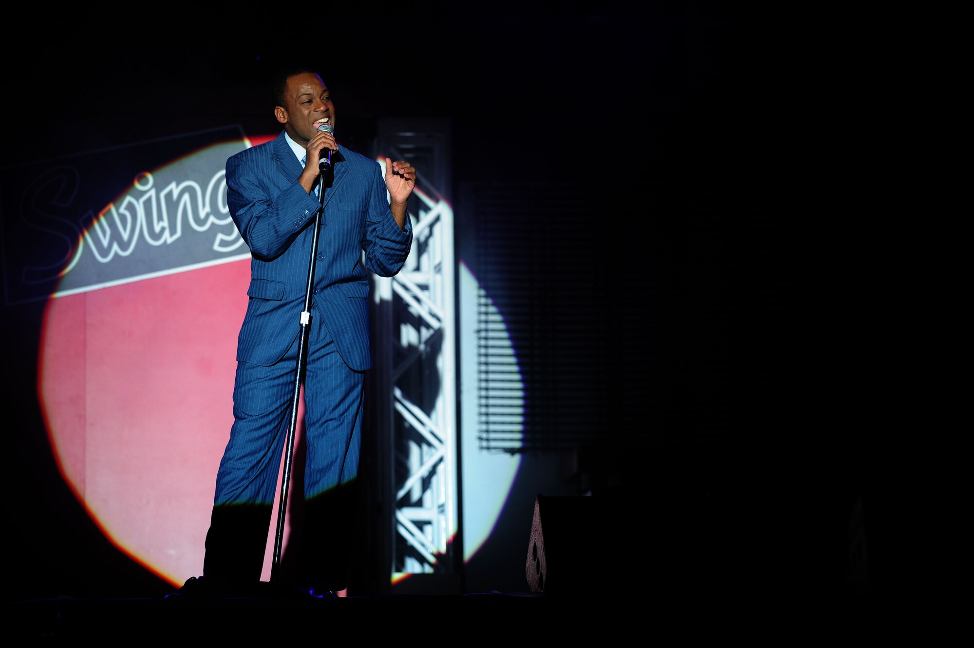 Staff Sgt. Tommie Crutcher, a Tops in Blue performer, sings at a concert inside the Freedom Hangar on Hurlburt Field, Fla., Feb. 11, 2012.  Tops in Blue, the premier entertainment showcase of the Air Force, has been playing for nearly 60 years. (U.S. Air Force photo/Airman 1st Class Gustavo Castillo)(Released)