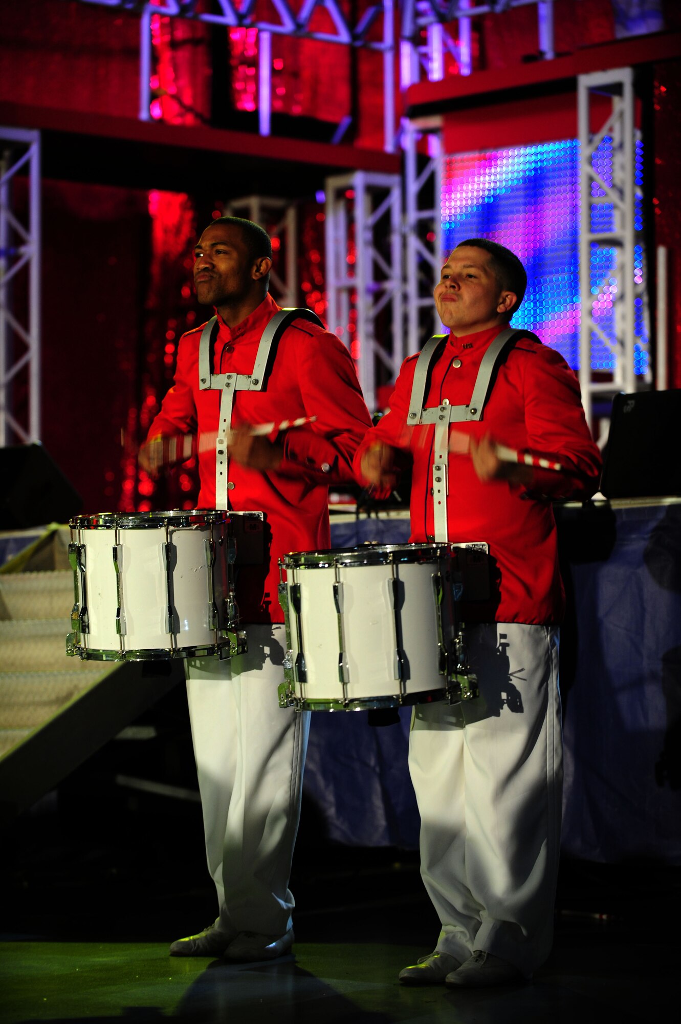 Airman 1st Class Steve Pearson, left, and Senior Airman Zachery Rayburn, both Tops in Blue vocalists, play snare drums at a concert inside the Freedom Hangar on Hurlburt Field, Fla., Feb. 11, 2012.  Tops in Blue performs to more than 300 Airmen and their families while at the hangar. (U.S. Air Force photo/Airman 1st Class Gustavo Castillo)(Released)