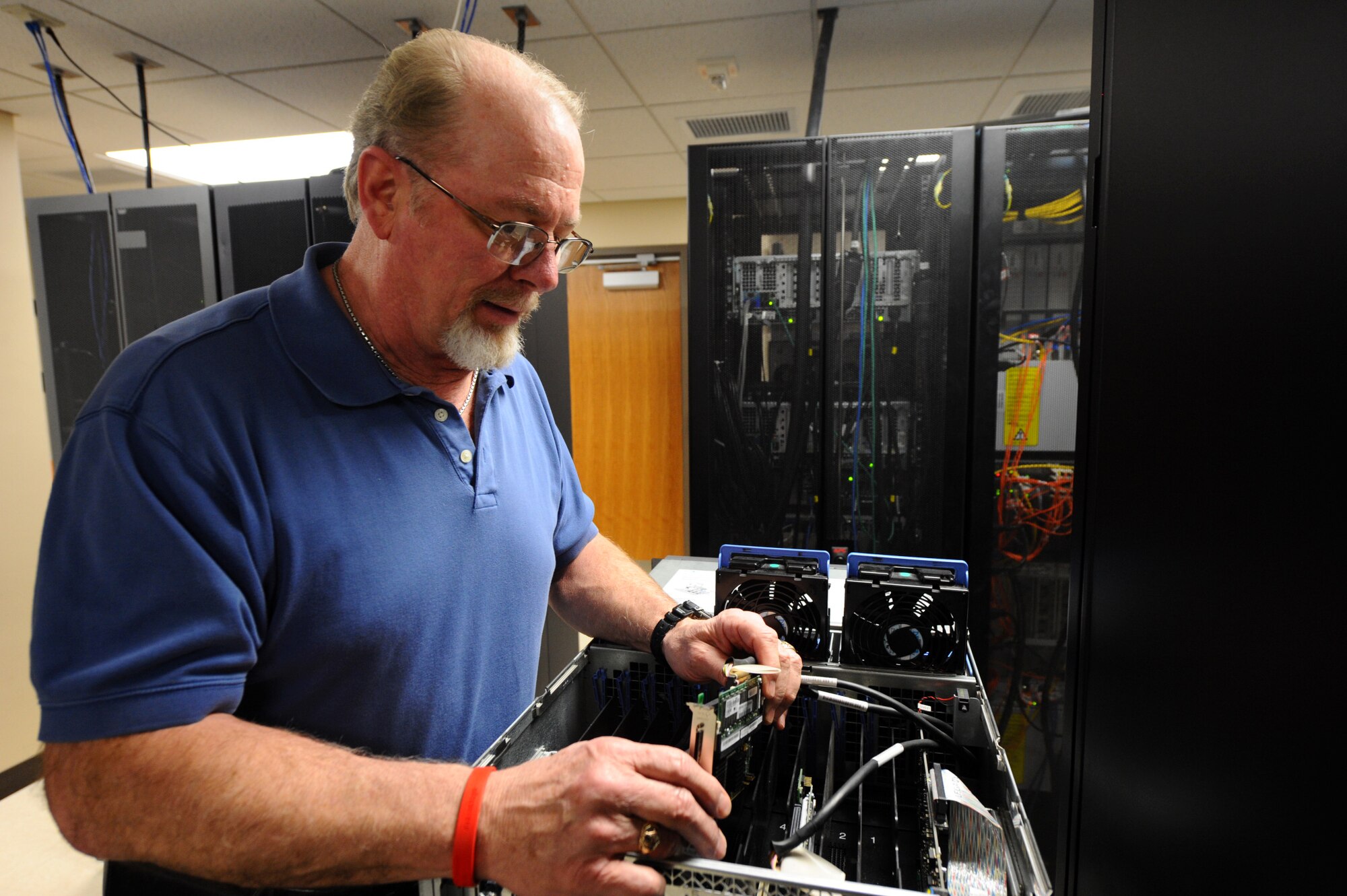 Charles Counsellor, 28th Medical Support Squadron medical information services flight chief, installs a communications module to an application server on Ellsworth Air Force Base, S.D., Jan. 31, 2012. The application server hosts Ellsworth’s medical Integrated Clinical Data Base which allows the Electronic Health Record to analyze health care information on active duty service members, dependents and retirees. (U.S. Air Force by Airman 1st Class Zachary Hada/Released)