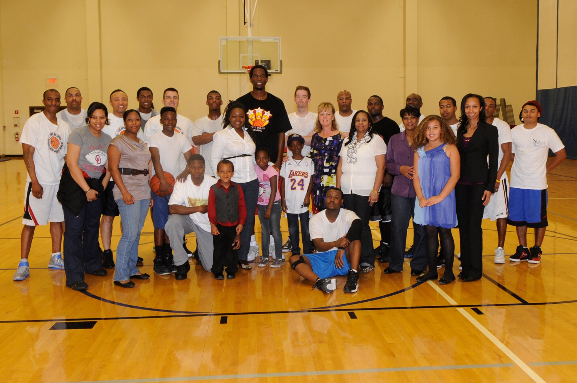 VANDENBERG AIR FORCE BASE, Calif. – A.C. Green, a motivational speaker and retired National Basketball Association player, poses for a group photo with the Gospel Basketball Men’s Fellowship and their families here Sunday, Feb. 12, 2012. The fellowship is held every other Sunday at 2:30 p.m. in the base gym. For more information contact the Vandenberg Air Force Base chapel staff at 606-5773. (U.S. Air Force photo/Tech. Sgt. Scottie T. McCord) 