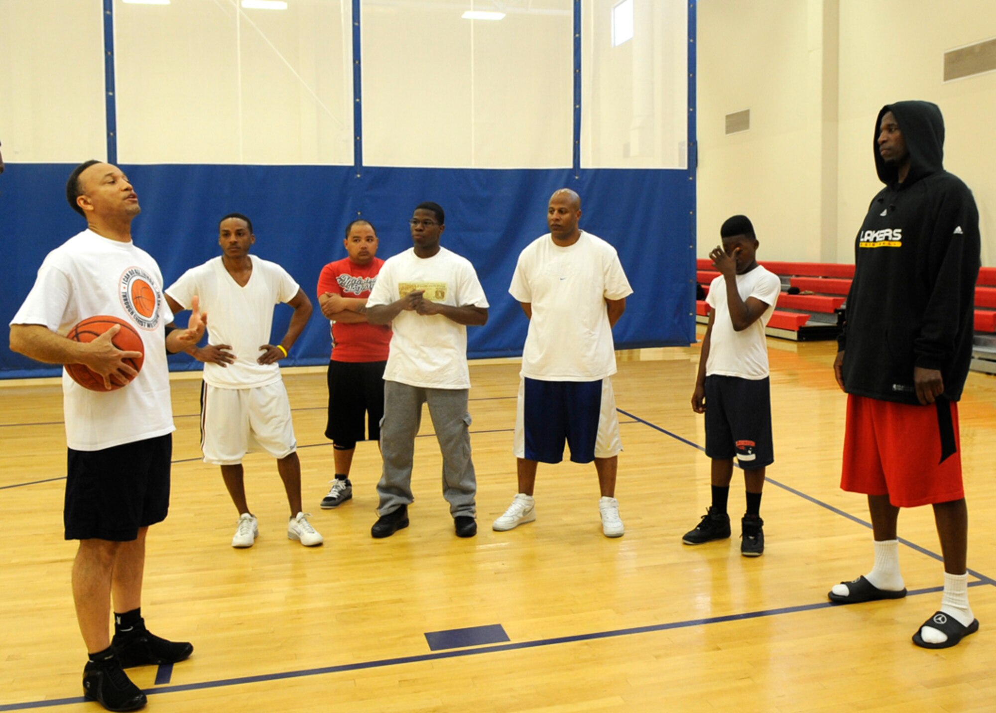 VANDENBERG AIR FORCE BASE, Calif. – Quinn Johnson, of the 30th Contracting Squadron, welcomes A.C. Green, a motivational speaker and retired National Basketball Association player, to the Gospel Basketball Men’s Fellowship here Sunday, Feb. 12, 2012. The fellowship is held every other Sunday at 2:30 p.m. in the base gym. For more information contact the Vandenberg Air Force Base chapel staff at 606-5773. (U.S. Air Force photo/Tech. Sgt. Scottie T. McCord) 