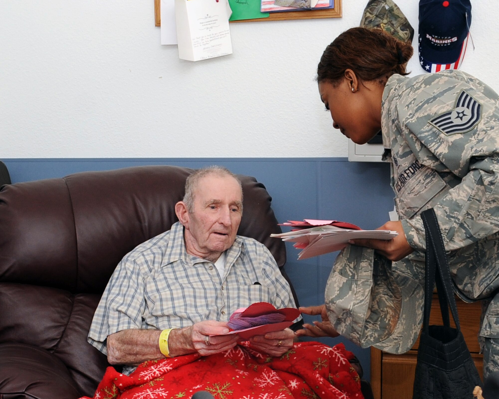 CLINTON, Okla. — Tech. Sgt. LaKisha Mount, 97th Medical Operations Squadron clinic operations flight chief, hands a Valentine’s Day card to Nolan Carter, U.S. Marine veteran at the Clinton Veteran’s Center Feb. 14, 2012. Valentine’s Day cards made by Altus elementary school students were handed out to veterans at four different locations by Altus Air Force Base volunteers. (U.S. Air Force photo by Senior Airman Leandra D. Stepp / 97th Air Mobility Wing Public Affairs / Released)   