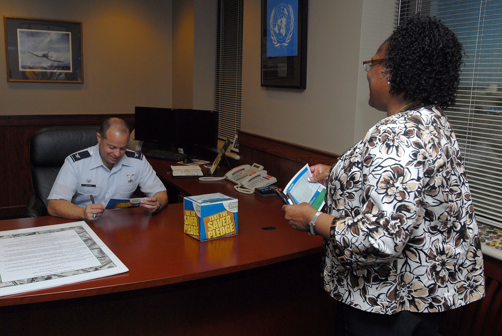 GOODFELLOW AIR FORCE BASE, Texas-- Essie Whitworth-Nurse, Airman & Family Readiness Center, talks to Col. Mark T. Damiano, 17th Training Wing Commander, about the benefits of the military saves program Feb. 14, here. The military saves program helps encourage service members to create budgets to better their finances.(U.S. Air Force photo/Airman 1st Class Michael Smith) 