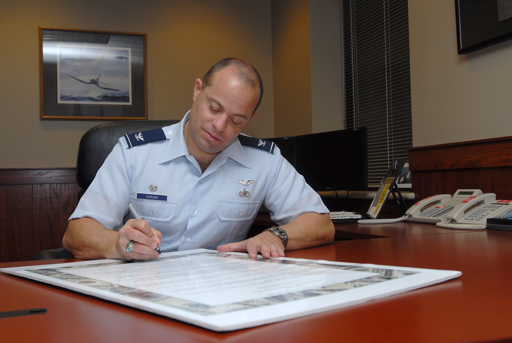 GOODFELLOW AIR FORCE BASE, Texas-- Col. Mark T. Damiano, 17th Training Wing Commander, signs the proclamation for the military saves program Feb. 14, here. The military saves program helps encourage service members to create budgets to better their finances.(U.S. Air Force photo/Airman 1st Class Michael Smith)
