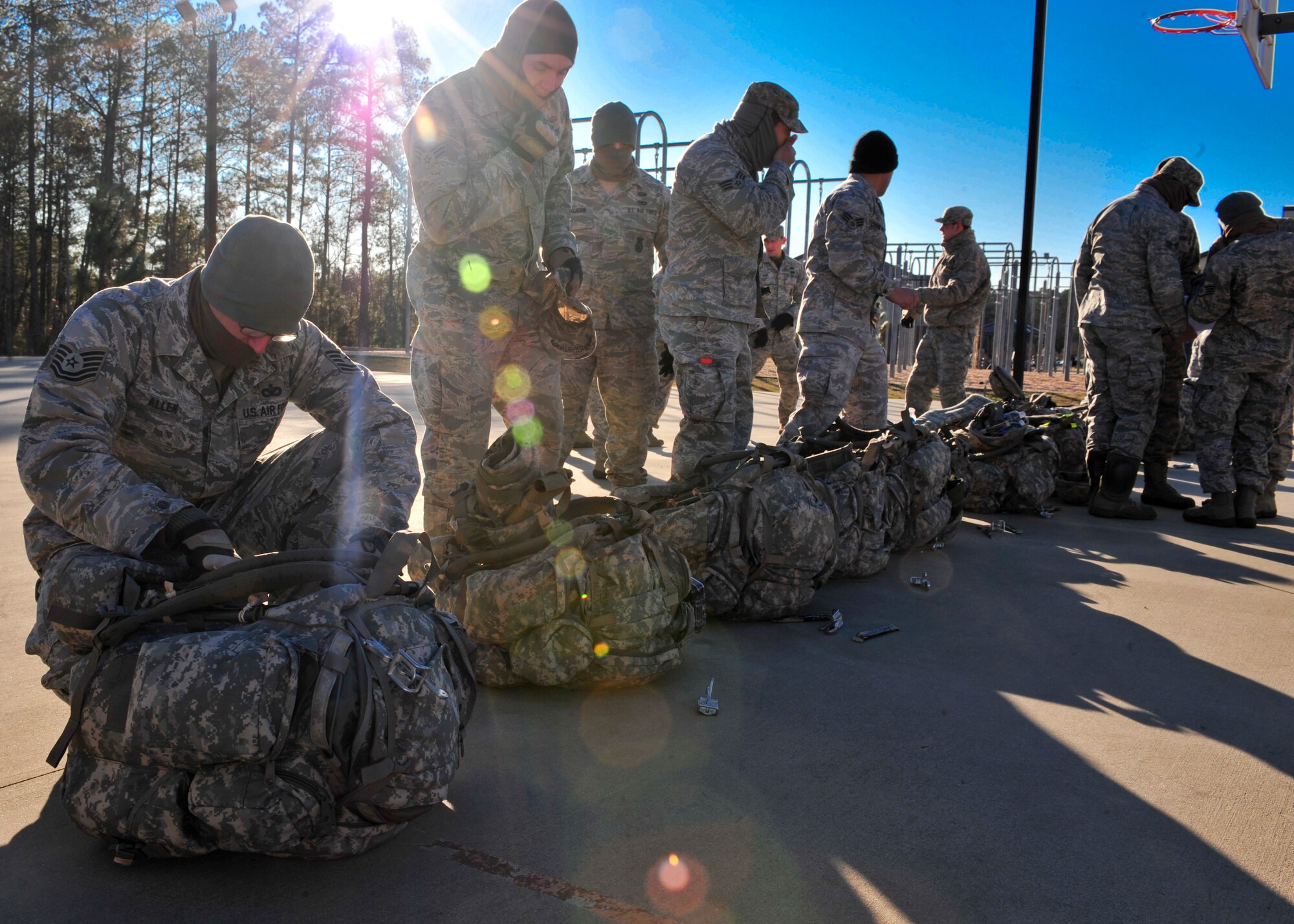 U.S. Air Force Airmen with the 824th Base Defense Squadron line up to receive their weapons and night vision goggles before jumping during Joint Operations Access Exercise 12-01 in Fort Bragg, N.C., Feb. 12. The 824th BDS was attached to the Headquarters and Headquarters Company, 3rd Brigade Special Troops Battalion, 3rd Brigade Combat Team, 82nd Airborne Division.  (U.S. Air Force photo by Staff Sgt. Stephanie Mancha/Released)