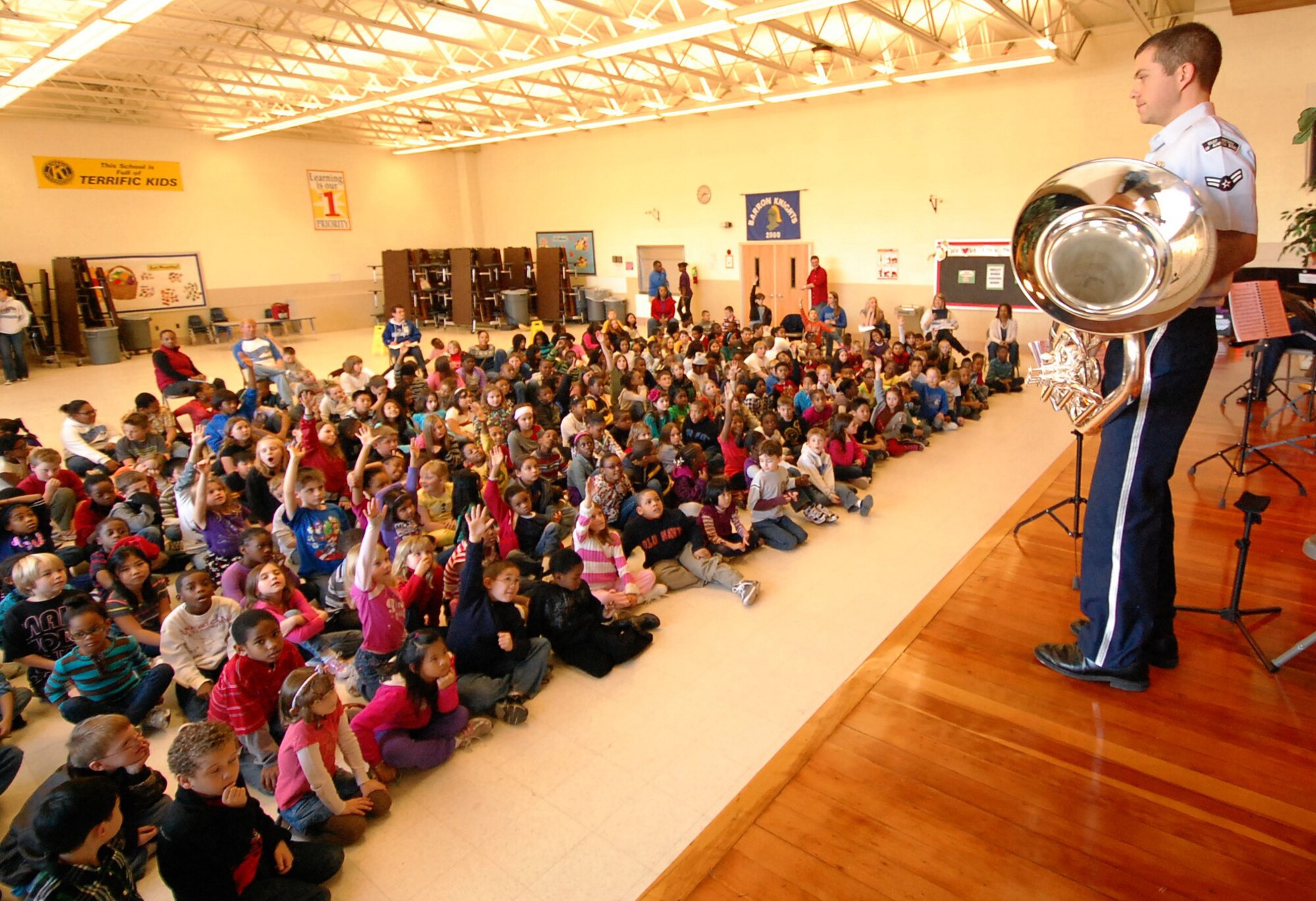 Airman 1st Class Bud Holmes, a U.S. Air Force Heritage of America Band’s Heritage Brass ensemble tuba player, speaks with students at Barron Elementary School in Hampton following a performance Feb. 3, 2012. The ensemble fielded questions from students about military life and teamwork, and recognized students who have parents, siblings or loved ones serving in the military. (U.S. Air Force photo by Ray Landon/Released)