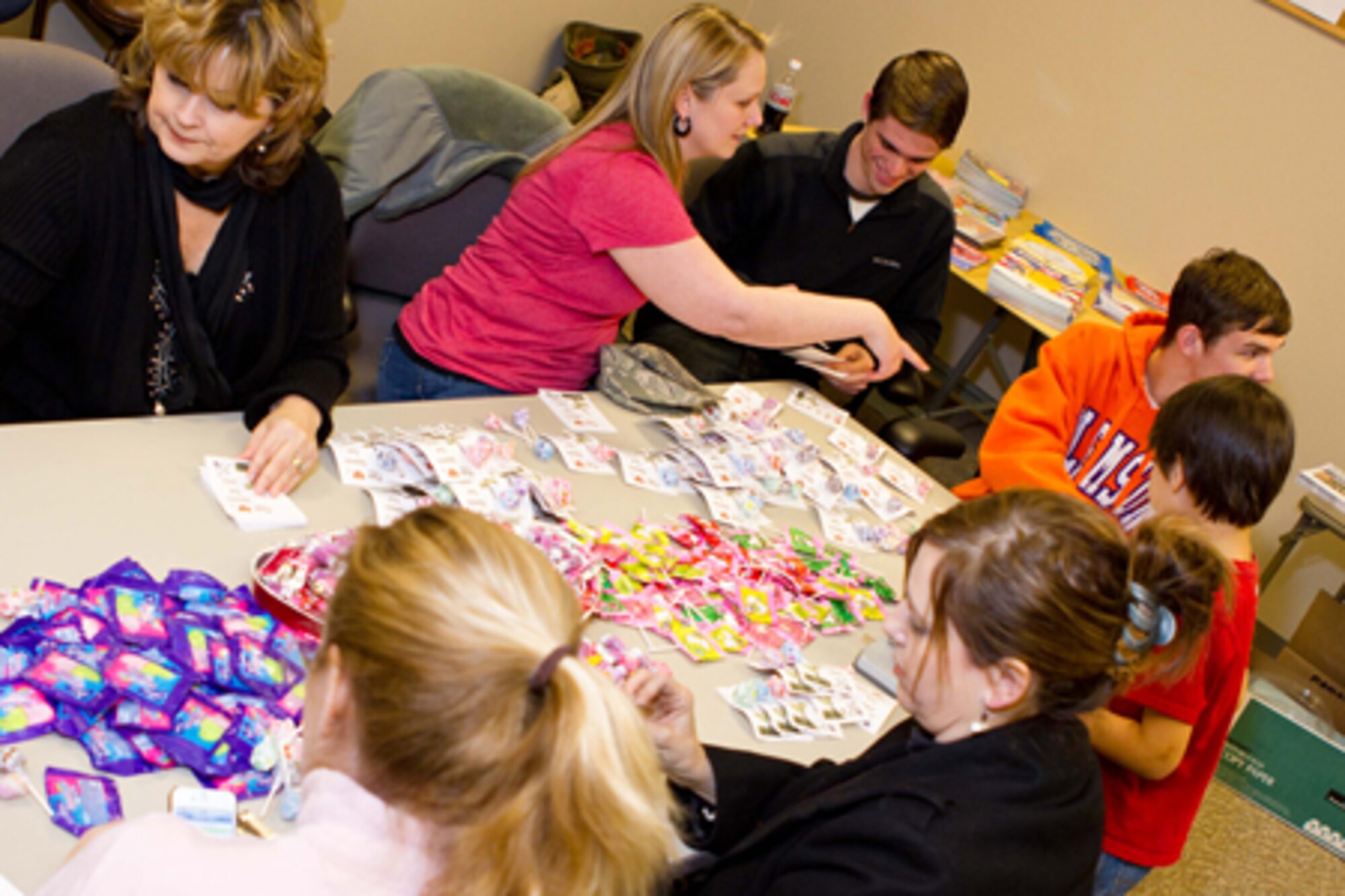 A group of family, friends and co-workers of deployed members of the 917th Fighter Group prepare Valentine’s Day cards and gifts to send to their loved ones overseas at Barksdale Air Force Base, La., Feb. 11, 2012. They also videotaped short messages that will be emailed to their loved ones on Valentine’s Day. (Courtesy photo by Donna Caughlin)  