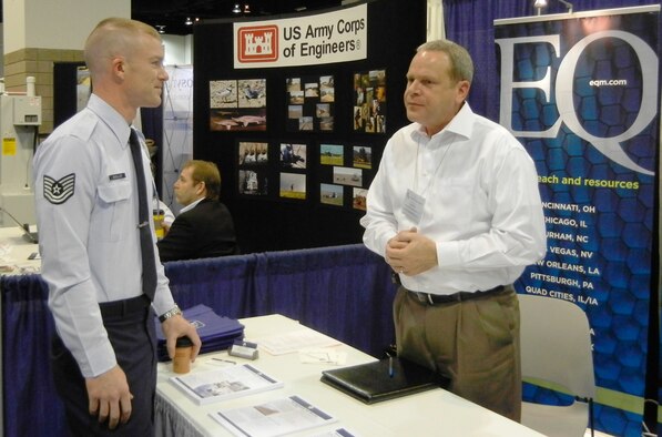 DENVER -- Tech. Sgt. Daniel Mueller, assigned to the 15th Aeromedical-Dental Squadron at Hickam Air Force Base, Hawaii, talks with Tom Wey from Environmental Quality Management Tuesday in the exhibit hall at the 20th annual Environment, Safety and Occupational Health Symposium at the Colorado Convention Center here.  (U.S. Air Force photo by Michael Briggs)