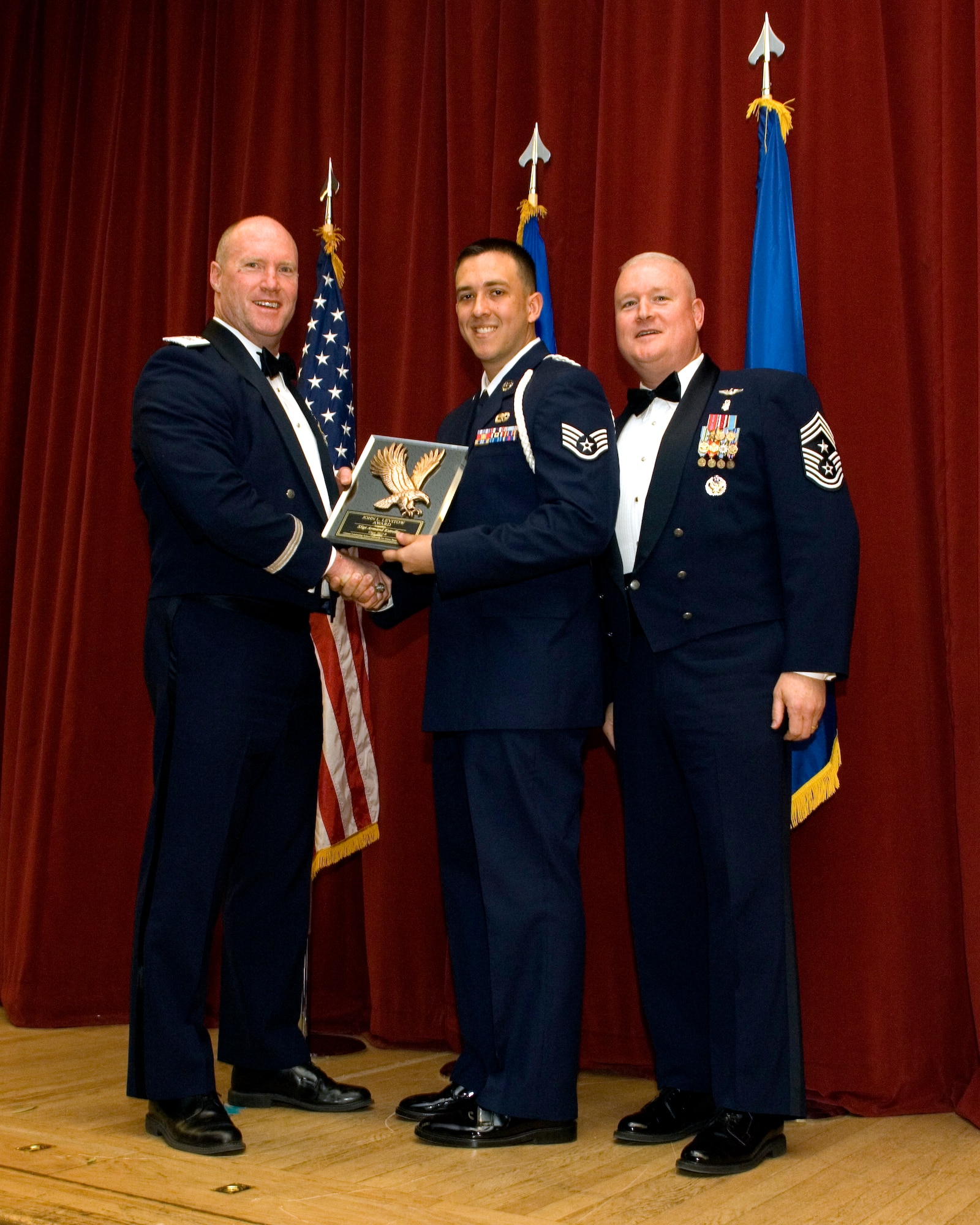 Staff Sgt. Armand Estrella, 912th Air Refueling Squadron, is congratulated by Brig. Gen. Robert C. Nolan II, Air Force Flight Test Center commander, and Chief Master Sgt. Bill Thomaston, 95th Air Base Wing command chief, for winning the John L. Levitow award, the highest honor presented to a graduate from Airman Leadership School. Estrella and the rest of Class 12-B graduated from ALS at the Stripes Lounge, Feb. 9. (U.S. Air Force photo by Edward Cannon)
