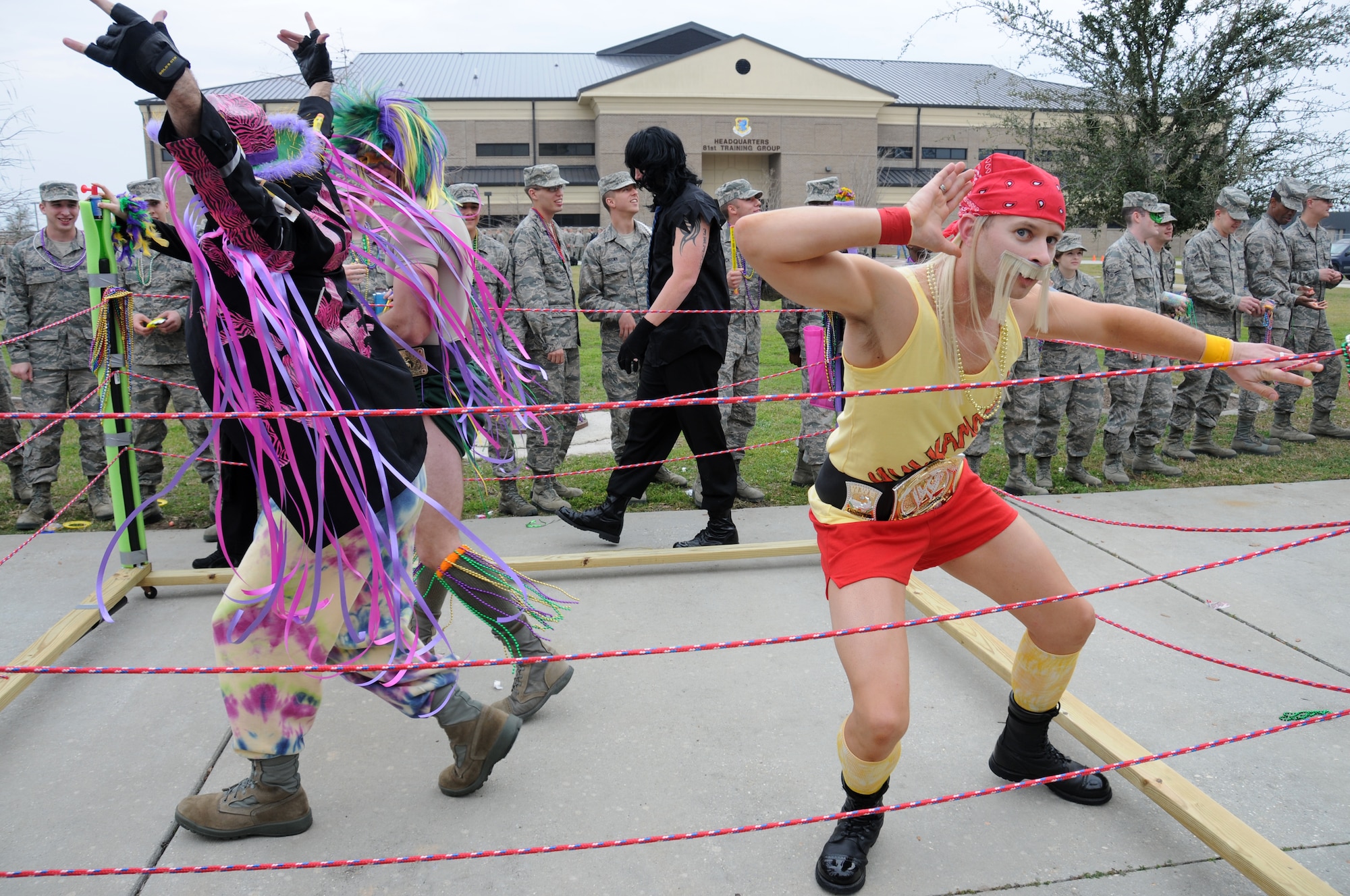 Tech. Sgt. Joseph Dill, 336th Training Squadron, dressed as “Hulk Hogan,” and other squadron members portray professional  wrestlers from the 1980s during the 81st Training Group Mardi Gras parade Feb. 10, 2012, between Thomson Hall and Matero Hall at Keesler Air Force Base, Biloxi, Miss.  They won first place for best theme during the parade.  (U.S. Air Force photo by Kemberly Groue)