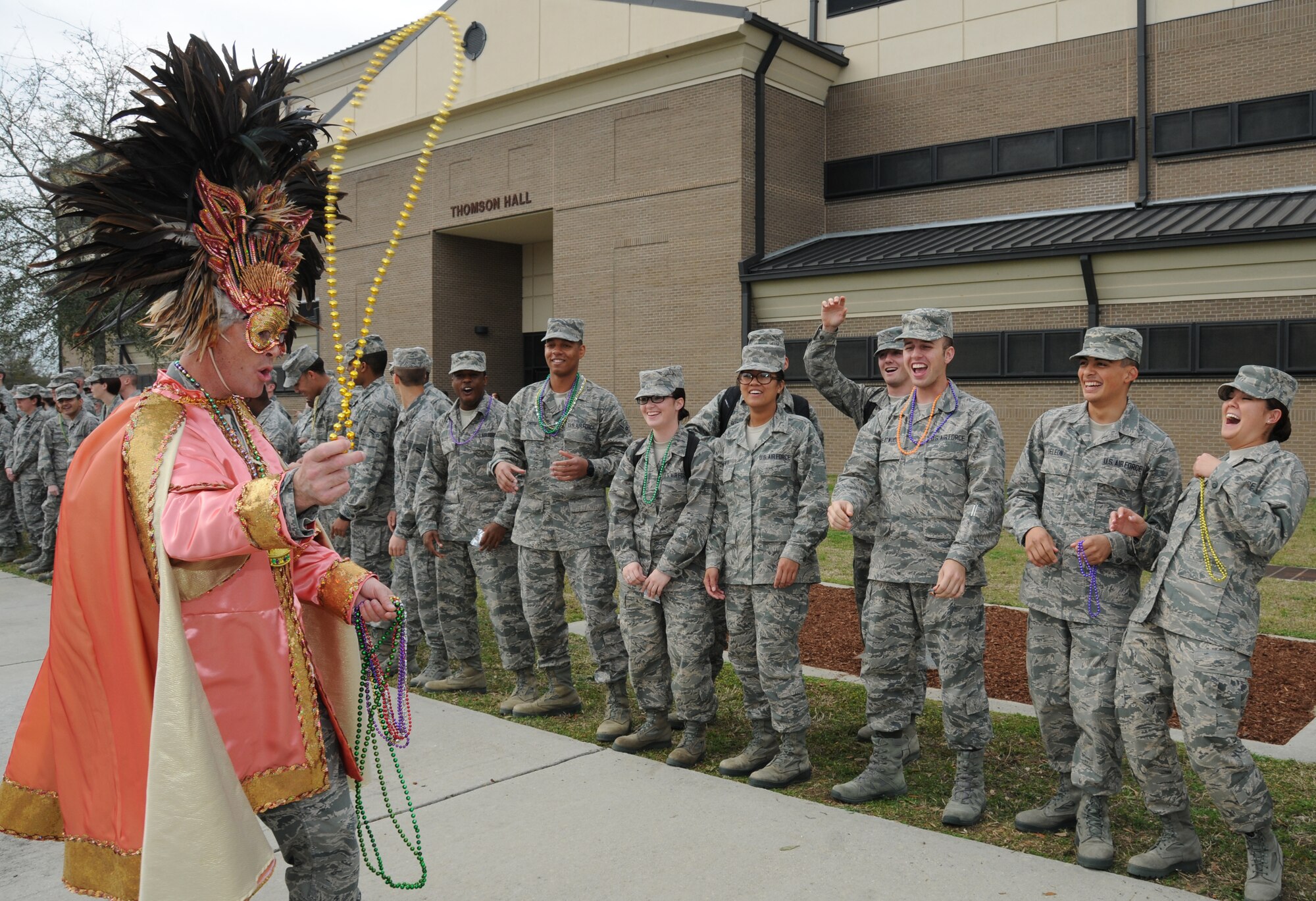 Lt. Col. Brian Worth, 336th Training Squadron commander, teases the crowd with a strand of beads during the 81st Training Group Mardi Gras parade Feb. 10, 2012.  The parade stretched from Thomson Hall to Matero Hall at Keesler Air Force Base, Biloxi, Miss.   (U.S. Air Force photo by Kemberly Groue)