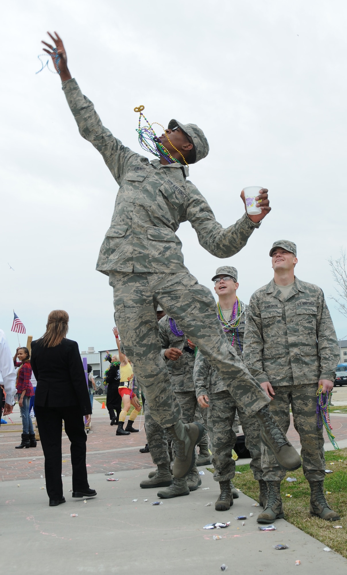 Airman Basic Jalen Edmonds, 336th Training Squadron, jumps to catch a bead after being tossed by floats during the 81st Training Group Mardi Gras parade Feb. 10, 2012, between Thomson Hall and Matero Hall at Keesler Air Force Base, Biloxi, Miss.  (U.S. Air Force photo by Kemberly Groue)