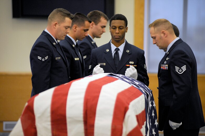 Senior Airman Western Chase stands at the end of an empty casket draped by a U.S. Flag during a training session for the 127th Wing Honor Guard at Selfridge Air National Guard Base, Mich., Feb. 10, 2012. In addition to the empty casket, volunteers acted as “grieving family members” to assist honor guard trainees learn the appropriate ceremonial honors to be rendered at a veteran’s funeral. The honor guard held a training session to qualify six new Airmen to serve as members of the unit. (U.S. Air Force photo by John S. Swanson)