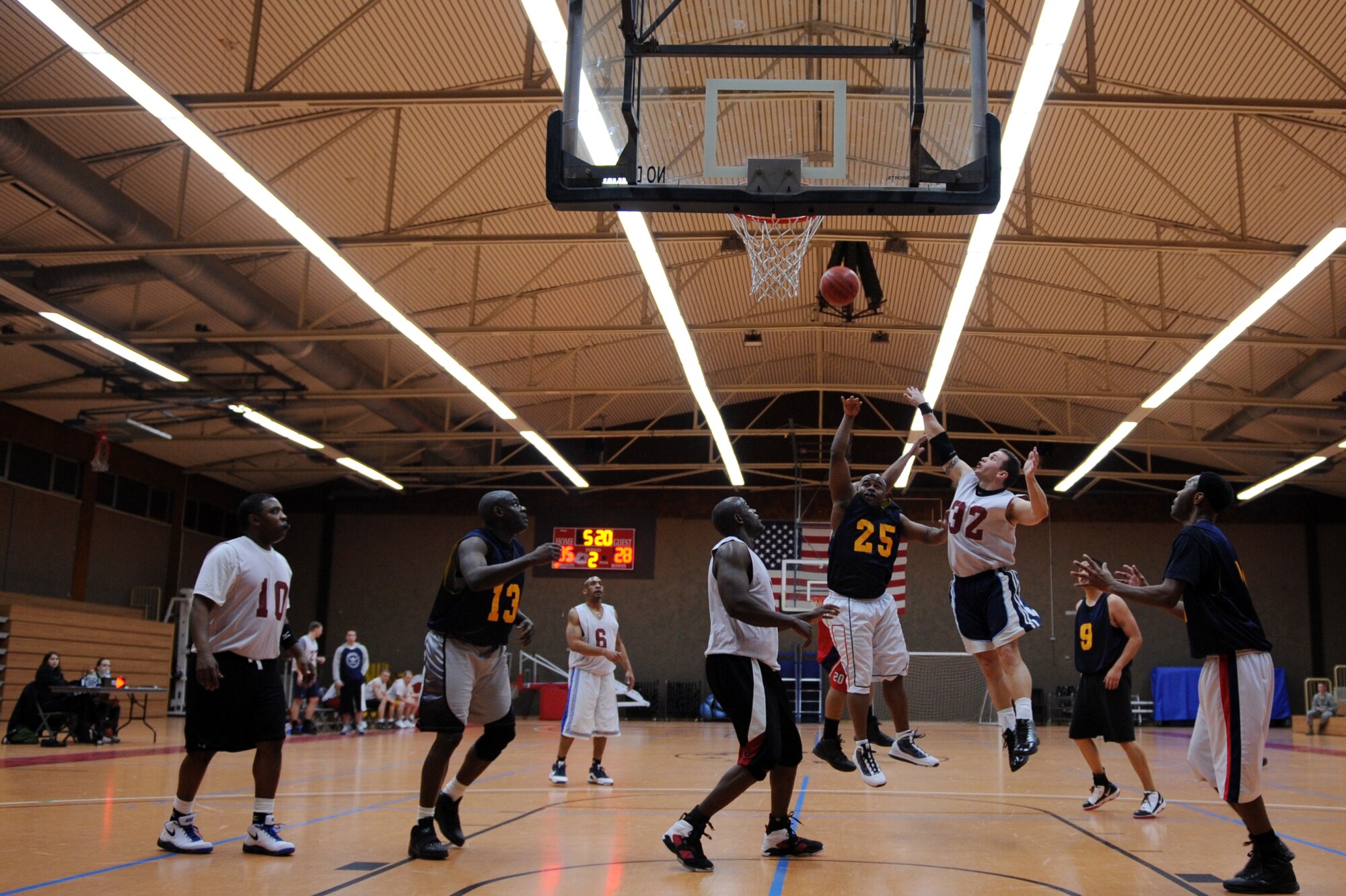 SPANGDAHLEM AIR BASE, Germany – Richard Goines, 52nd Communications Squadron, shoots over Mark Dewitz, 726th Air Mobility Squadron, during the over-30 basketball league championship game at the Skelton Memorial Fitness Center here Feb. 13. The AMS defeated the CS 48-35 to win the championship game with an undefeated record. (U.S. Air Force photo by Airman 1st Class Matthew B. Fredericks/Released)
