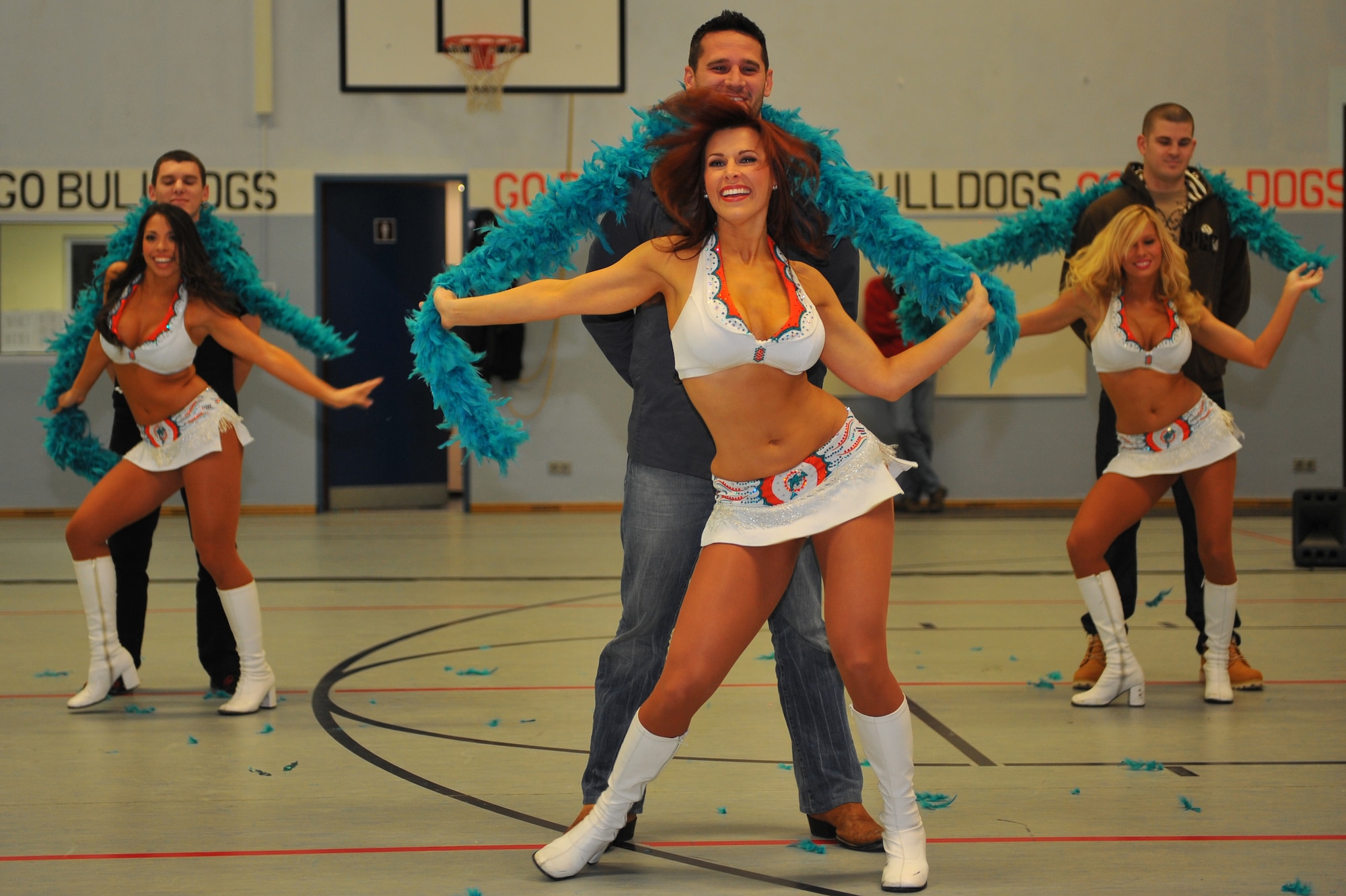 SPANGDAHLEM AIR BASE, Germany – Miami Dolphins cheerleaders dance with members of the audience during a cheerleading demonstration at the Spangdahlem Middle School here Feb. 10. The Miami Dolphins football players and cheerleaders toured various U.S. Air Force and Army bases in Europe as part of an Armed Forces Entertainment tour. The reason for the visit was to boost morale and entertain the base’s community. (U.S. Air Force photo by Airman 1st Dillon Davis/Released)