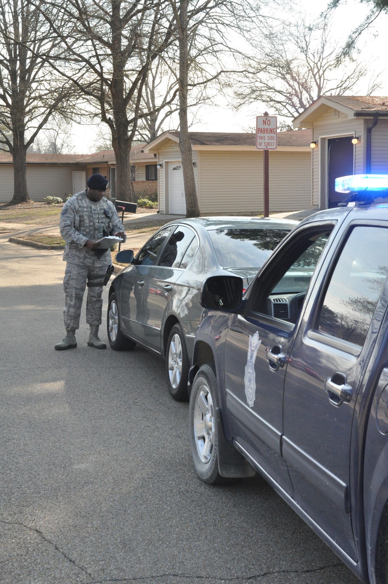 Tech. Sgt. Charleston Calhoun, 14th Security Forces Squadron, writes a ticket for an illegally parked car.  In most areas around Columbus Air Force Base it is illegal to park on the side of the road.  (U.S. Air Force Photo/Airman 1st Class Charles Dickens)