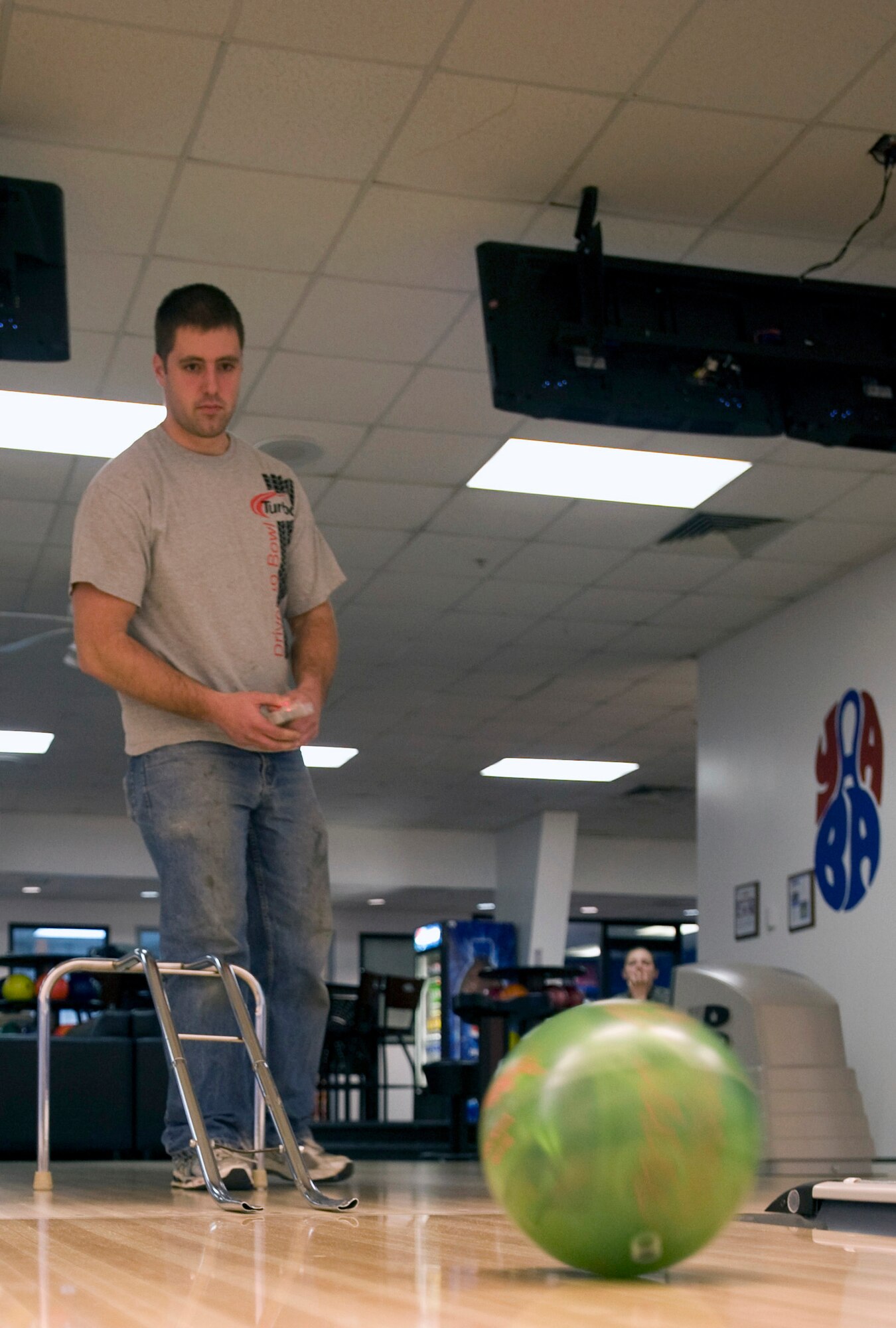 Andrew Saphore, a mechanic at the Eagle Lanes Bowling Center, demonstrates how to use the new remote-controlled bowling ball Feb. 9, 2012, at Dover Air Force Base, Del. The ball was given to the bowling alley for use by wounded service members. (U.S. Air Force photo by Senior Airman Matthew Hubby)