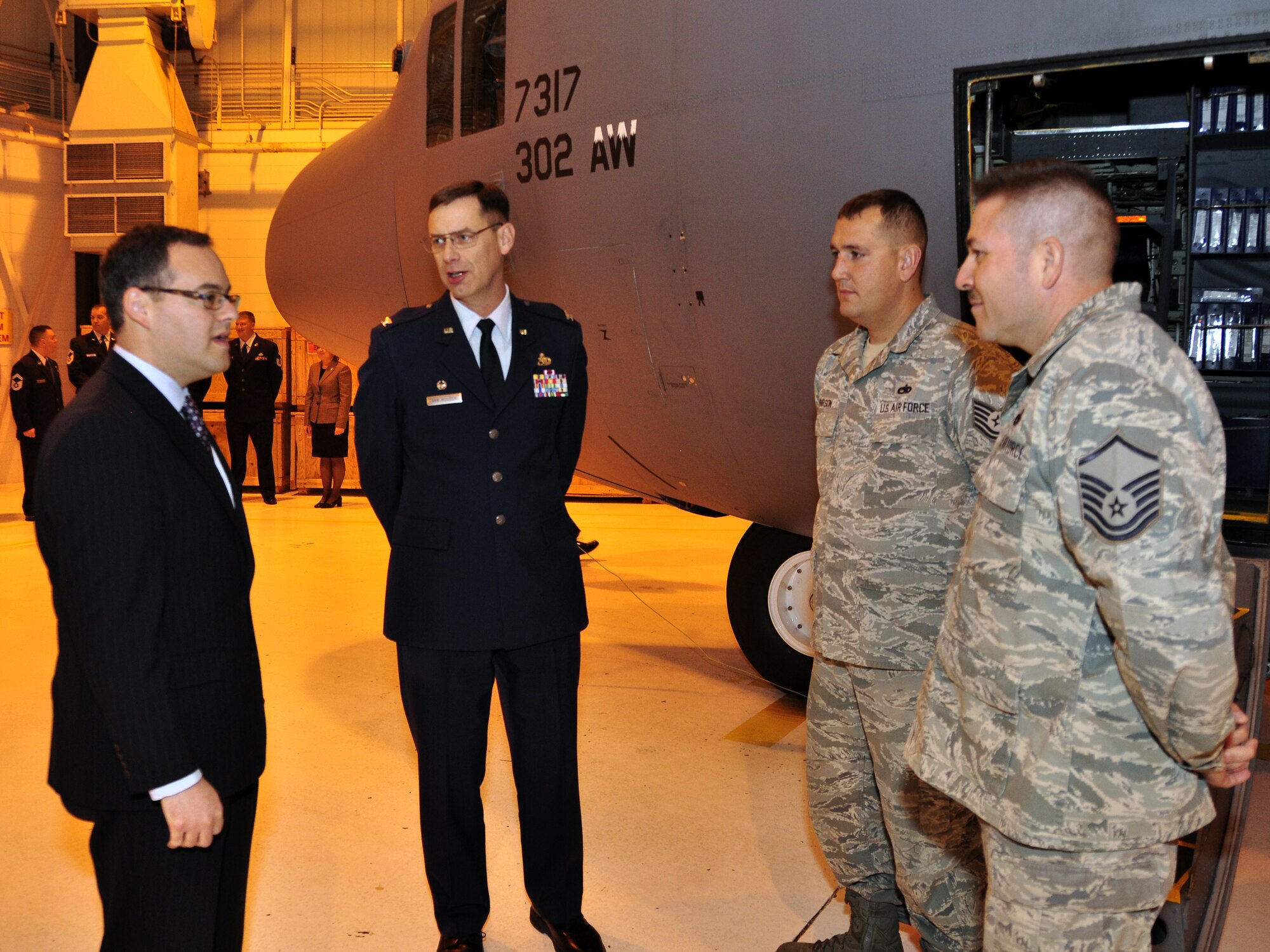 PETERSON AIR FORCE BASE, Colo. -- Col. James Van Housen, 302nd Maintenance Group commander, crew chiefs Master Sgt. Manuel Ortega, 302nd Maintenance Operations Flight, and Tech. Sgt. Stephen Pearson, 52nd Airlift Squadron, greet the Honorable Daniel B. Ginsberg, Assistant Secretary of the Air Force for Manpower and Reserve Affairs. The 302nd Airlift Wing hosted Ginsberg for a familiarization visit here, Feb. 8. (U.S. Air Force photo/Tech. Sgt. Peter Dean)