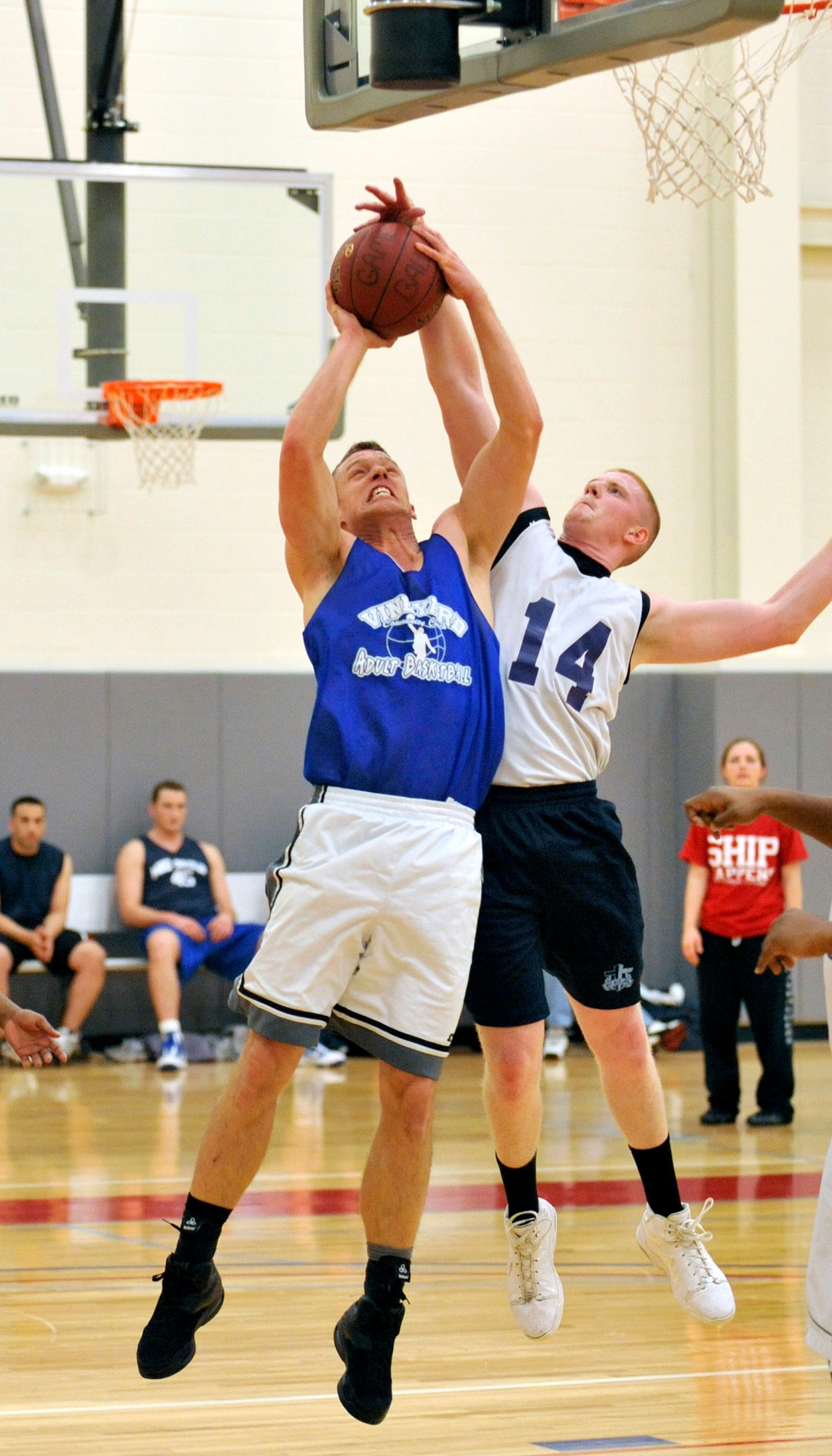 Aaron Williams of the 436th Medical Group drives in for a shot while Connor Cooney of the 512th Force Support Squadron blocks his shot during an intramural basketball game Feb. 8, 2012, at Dover Air Force Base, Del. The 512th FSS came back to defeat the 436th MDG 41-39. (U.S. Air Force photo by Tech. Sgt. Chuck Walker)