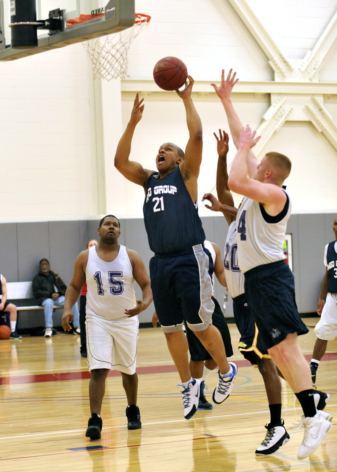 Ray Pitt, of the 436th Medical Group, drives in for a layup while the 512th Force Support Squadron tries to defend during an intramural basketball game Feb. 8, 2012, at Dover Air Force Base, Del. The 512th FSS defeated the 436th MDG 41-39. (U.S. Air Force photo by Tech. Sgt. Chuck Walker)