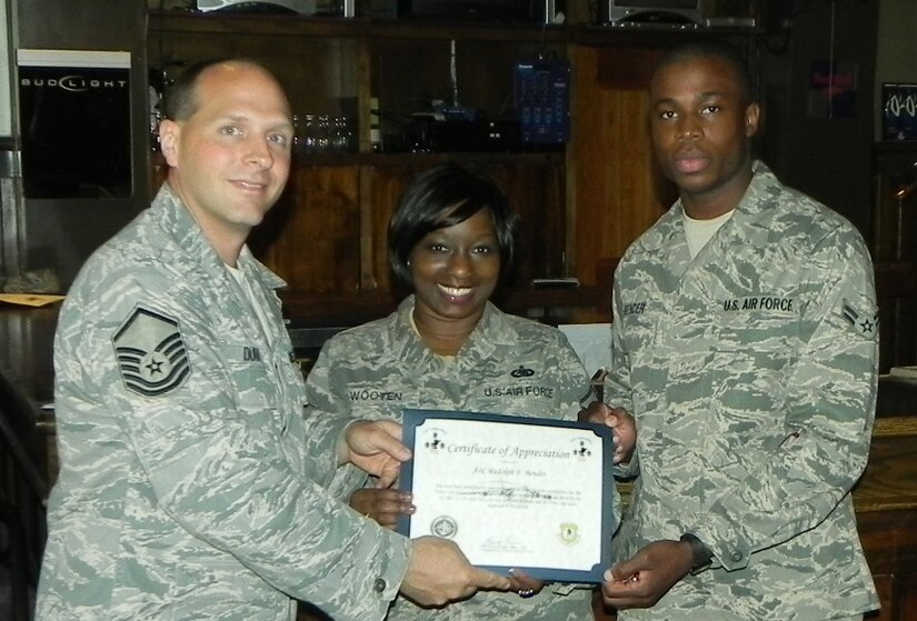 Master Sgt. Brady Durr (left) and Master Sgt. Dechanta Wooten (center) present a Top-3 coin and certificate to Airman 1st Class Rudolph Bender for being selected as a Top-3 Monthly Outstanding Performer at Joint Base Charleston – Air Base Feb. 8. Each month, the Top-3 organization recognizes Airmen who have made a significant impact on their unit’s mission. Bender and Wooten are assigned to the 628th Logistics Readiness Squadron and Durr is assigned to the 437th Operations Support Squadron, 437th Airlift Wing and is the Top-3 president. (Courtesy photo)