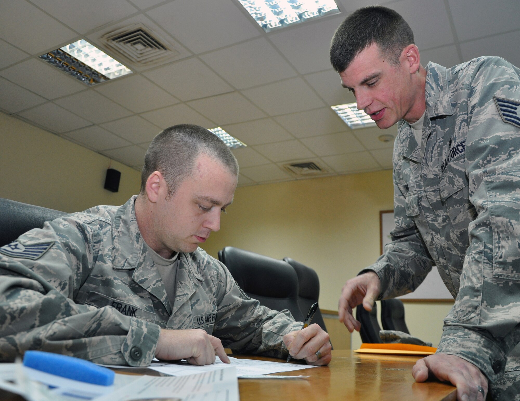 Tech. Sgt. Gregory Frank (left), 386th Air Expeditionary Wing Manpower Office, fills out a bone marrow donor form with the help of Tech. Sgt. Justin King, 386th Expeditionary Force Support Squadron, at an undisclosed location, Southwest Asia, Feb. 12, 2012. King received word during his deployment that he was a potential bone marrow match for a one-year-old girl with Hurler’s disease in the C.W. Bill Young Department of Defense Marrow Donor Program.  King is assisting Frank in the initial steps of signing up to become a bone marrow donor, before King redeploys home in preparation for the next step in the donation process. King is a Pittstown, N.Y., native deployed from the 4th Medical Support Squadron in Seymour-Johnson Air Force Base, N.C., and Frank is a native of Nelsonville, Ohio, deployed from the 3rd Manpower Requirements Squadron, Scott Air Force Base, Ill.  (U.S. Air Force photo/Tech. Sgt. Stacy Fowler)
