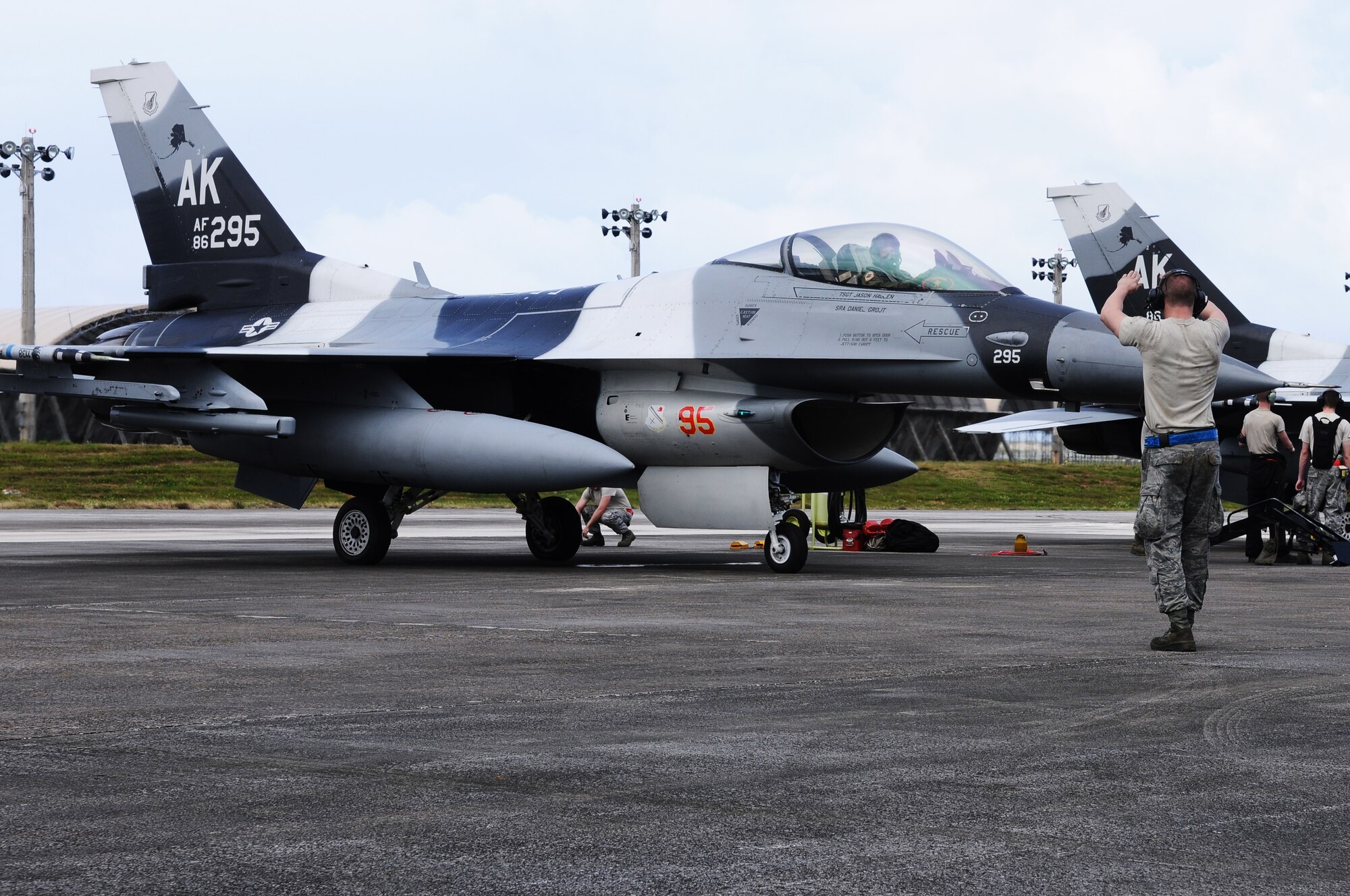 ANDERSEN AIR FORCE BASE, Guam- A maintainer from the 18th Aggressor Squadron, Eielson Air Force Base, Alaska, marshals an F-16 Fighting Falcon Aggressor forward to do final checks for pre-flight, Feb. 14. The 18 AS is here supporting Cope North 2012 playing as the opposing force against the other services participating. (U.S. Air Force photo/Senior Airman Carlin Leslie) 