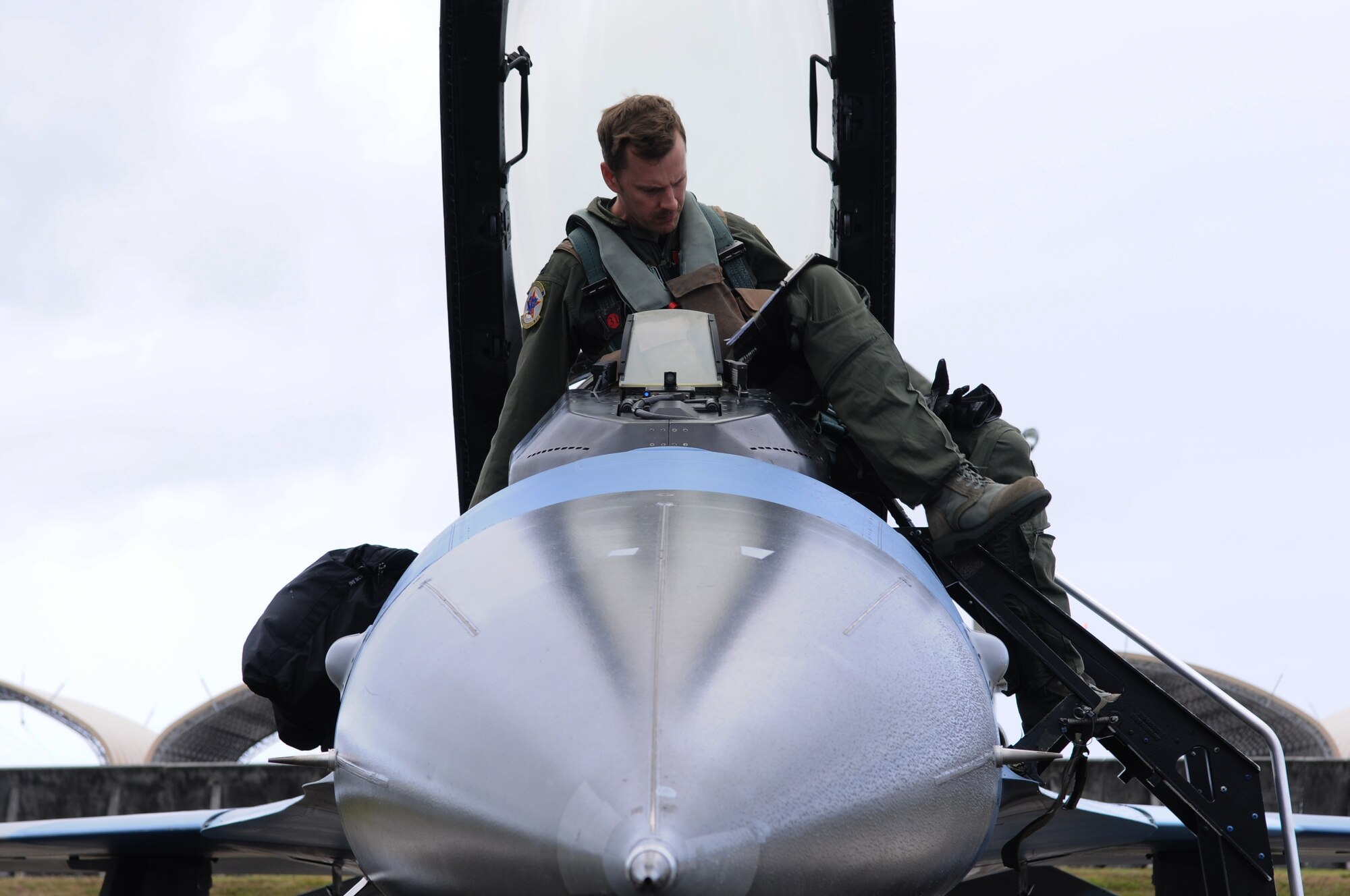 ANDERSEN AIR FORCE BASE, Guam- A pilot from the 18th Aggressor Squadron, Eielson Air Force Base, Alaska, gets into the cockpit of an F-16 Fighting Falcon during Cope North 2012, Feb. 14. The 18 AS is here in support of Cope North 2012, flying as the opposing force to the other aircraft participating in the Exercise. (U.S. Air Force photo/Senior Airman Carlin Leslie)